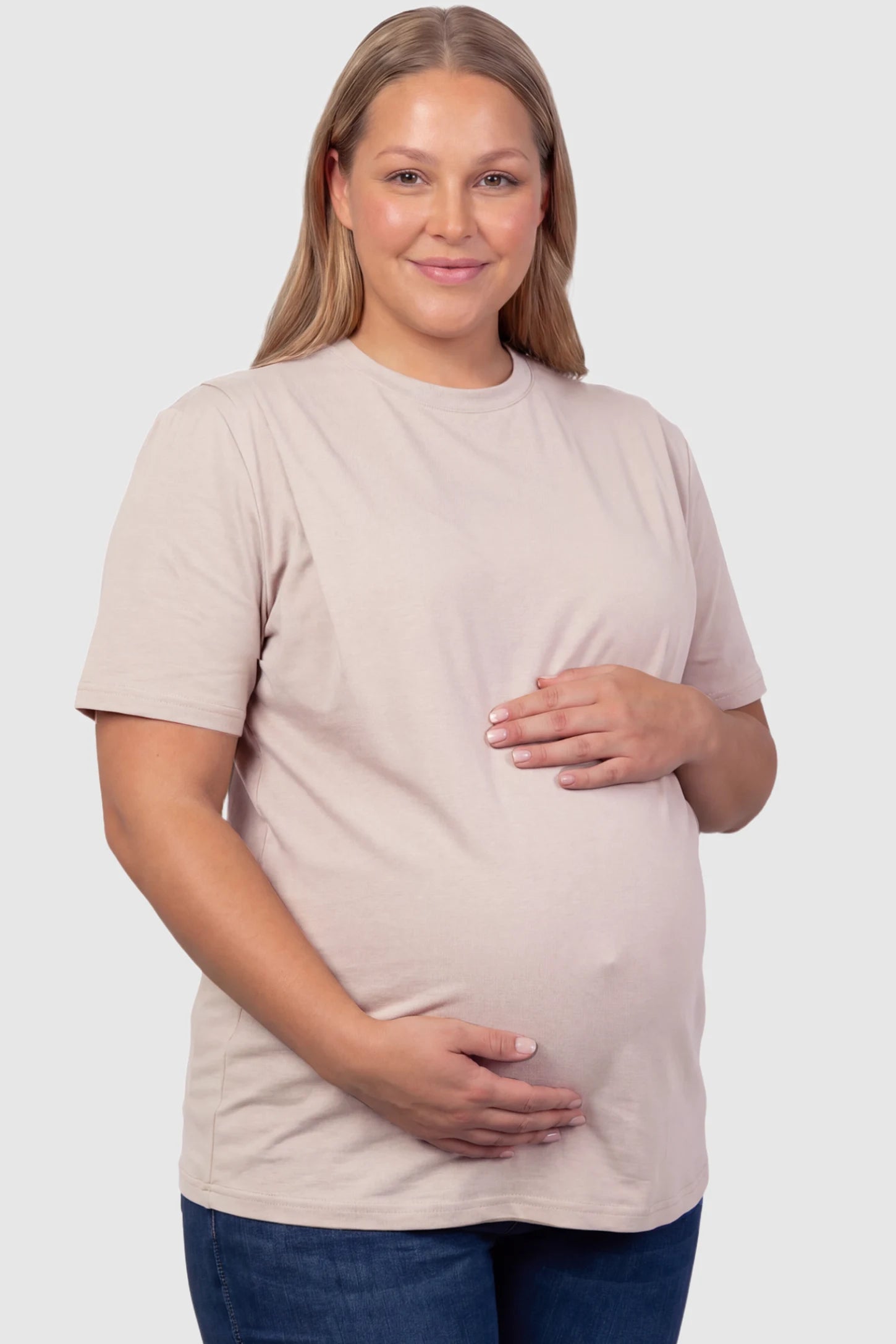 Solid Round Neck Short Sleeve Maternity Top Solid Round Neck Short Sleeve Maternity Top in Brown featuring a soft-touch finish and relaxed fit on a plus size pregnant model, front view.