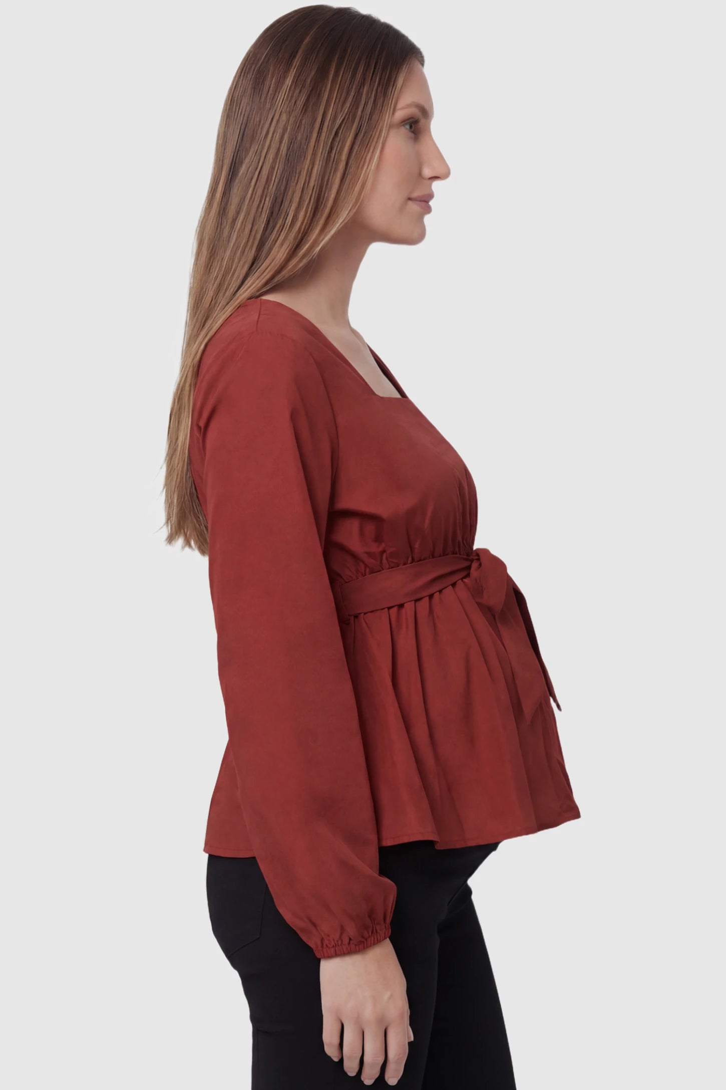 Solid Square Neck Empire Waist Maternity Top in Burgundy featuring a lightweight peplum silhouette and long sleeves on a pregnant model side view.