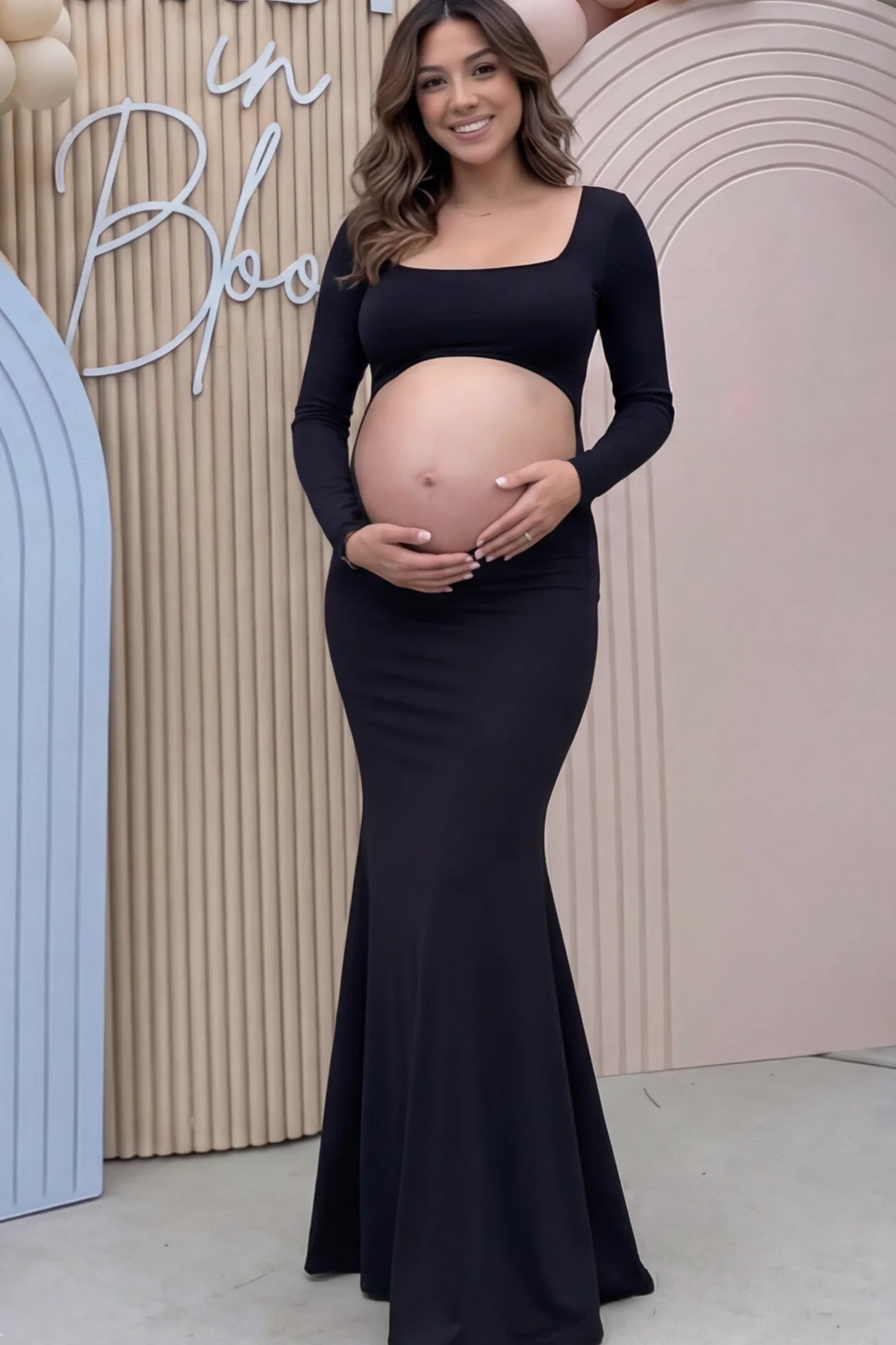 Solid Square Neck Long Sleeve Maternity Maxi Dress Solid Square Neck Long Sleeve Maternity Maxi Dress in black featuring a bold belly cut-out on a pregnant model showing front.