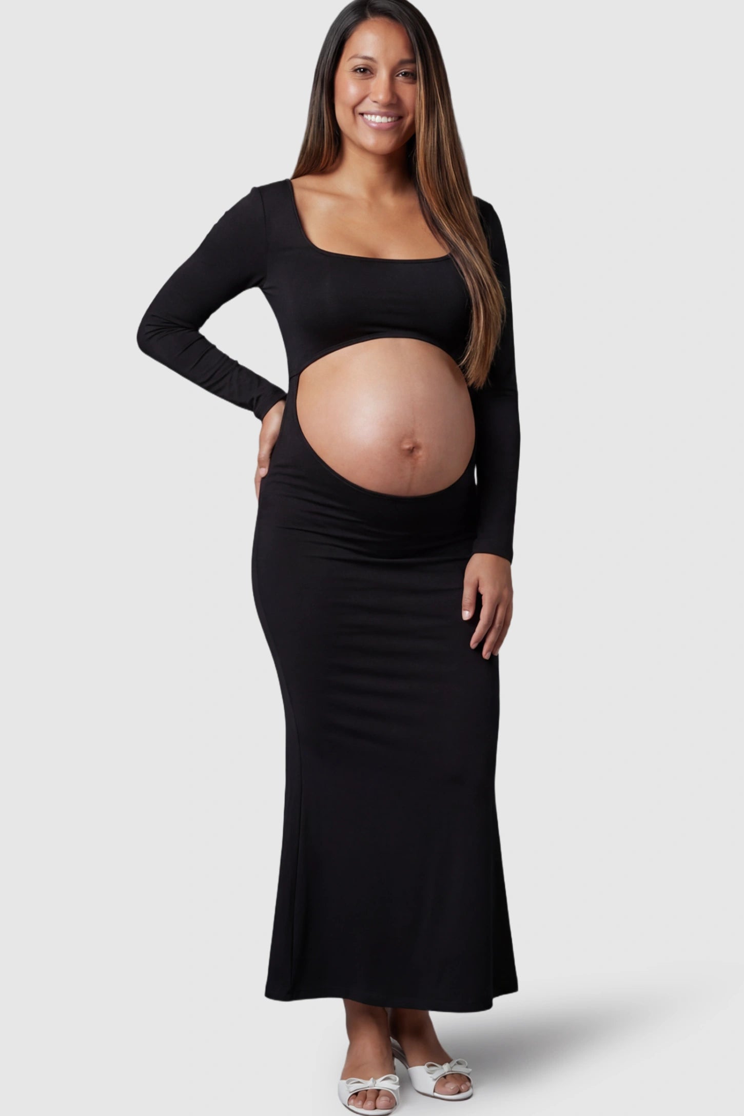 Solid Square Neck Long Sleeve Maternity Maxi Dress in black featuring a bold belly cut-out on a pregnant model showing front.