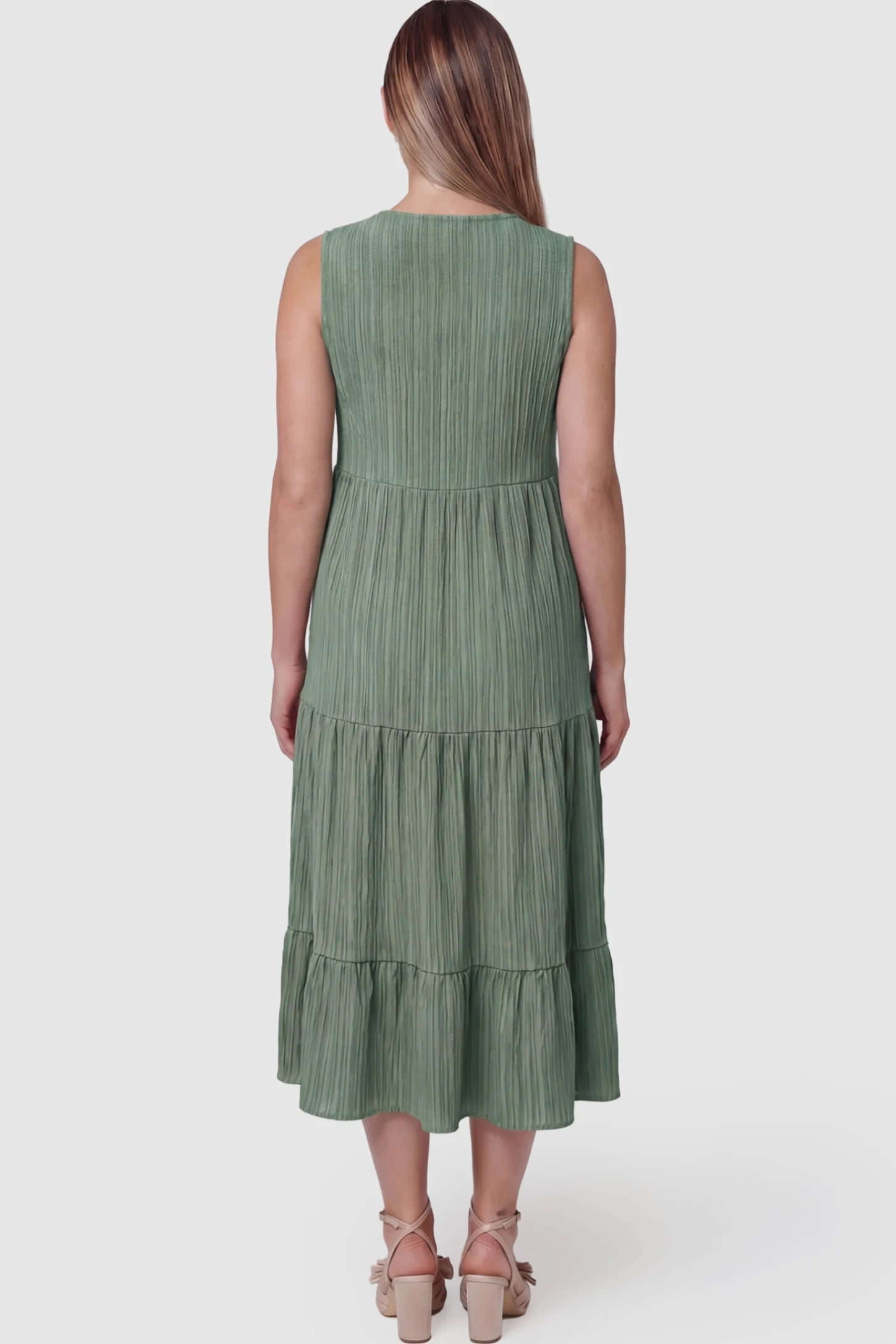 Solid Textured V-Neck Tiered Maternity Midi Dress Solid Textured V-Neck Tiered Maternity Midi Dress in Green featuring a high-waisted A-line silhouette on a pregnant model showing back.