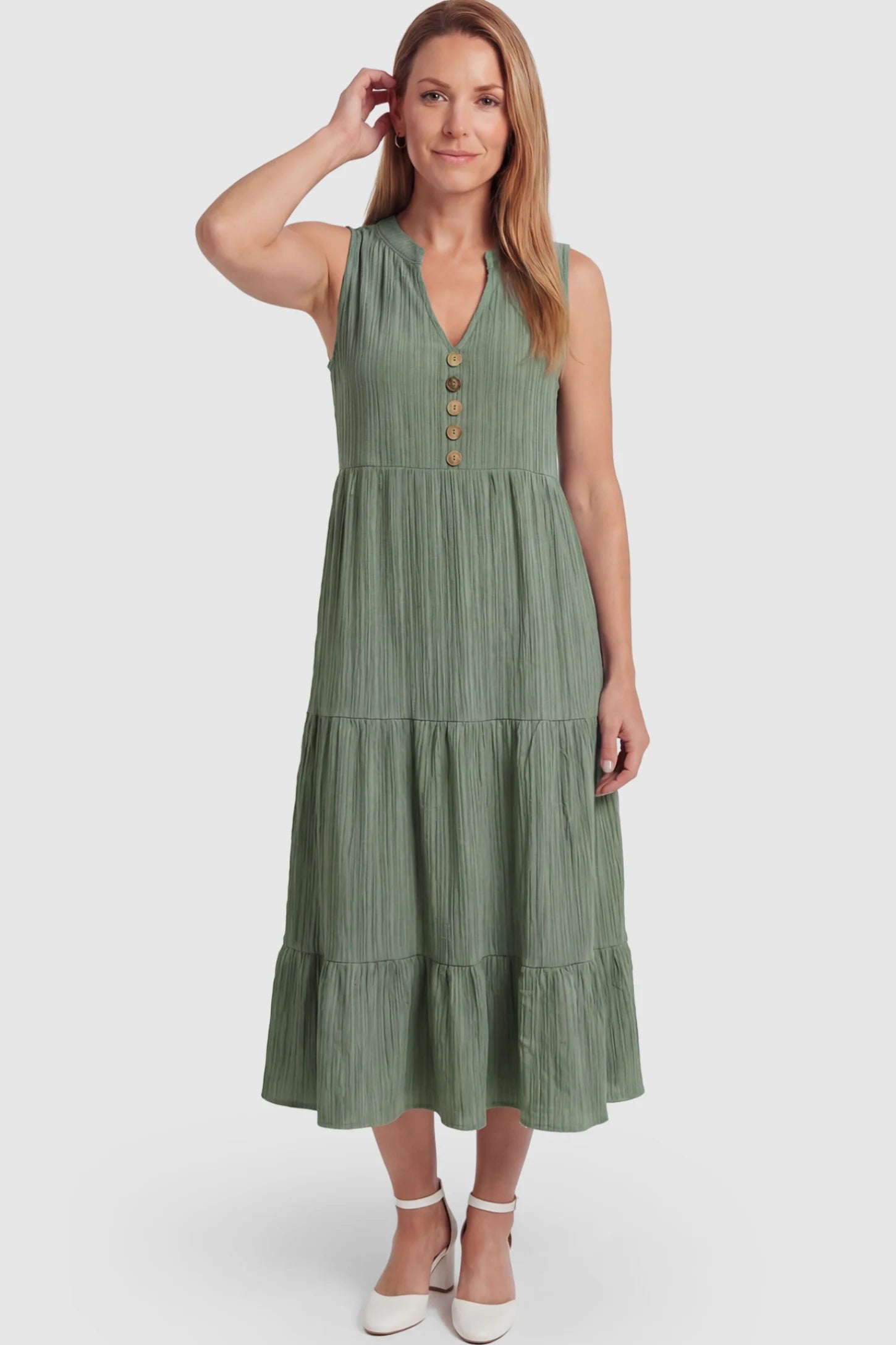 Solid Textured V-Neck Tiered Maternity Midi Dress Solid Textured V-Neck Tiered Maternity Midi Dress in Green featuring a high-waisted A-line silhouette on a postpartum model.