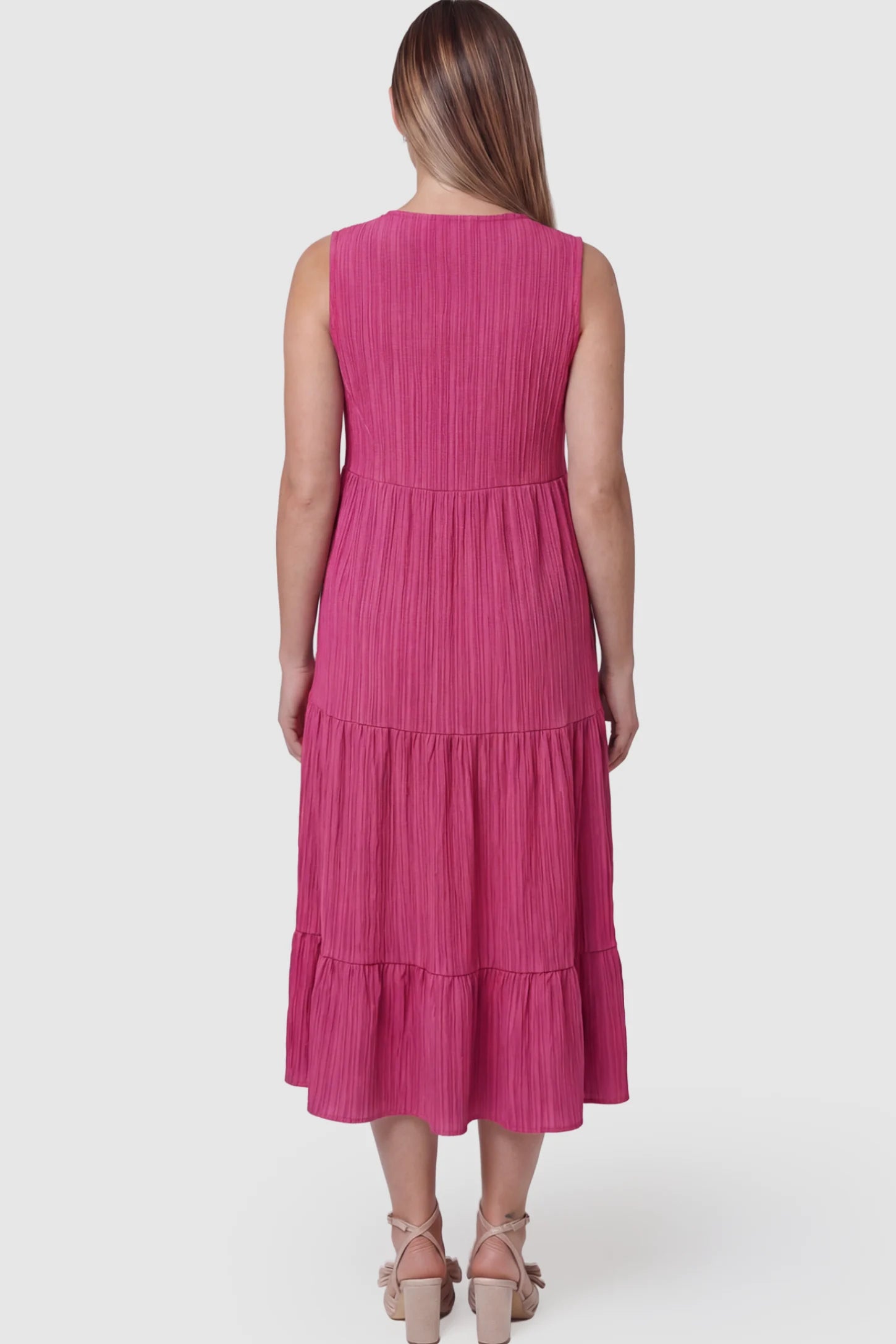 Solid Textured V-Neck Tiered Maternity Midi Dress Solid Textured V-Neck Tiered Maternity Midi Dress in Rose Red featuring a high-waisted A-line silhouette on a pregnant model showing back.