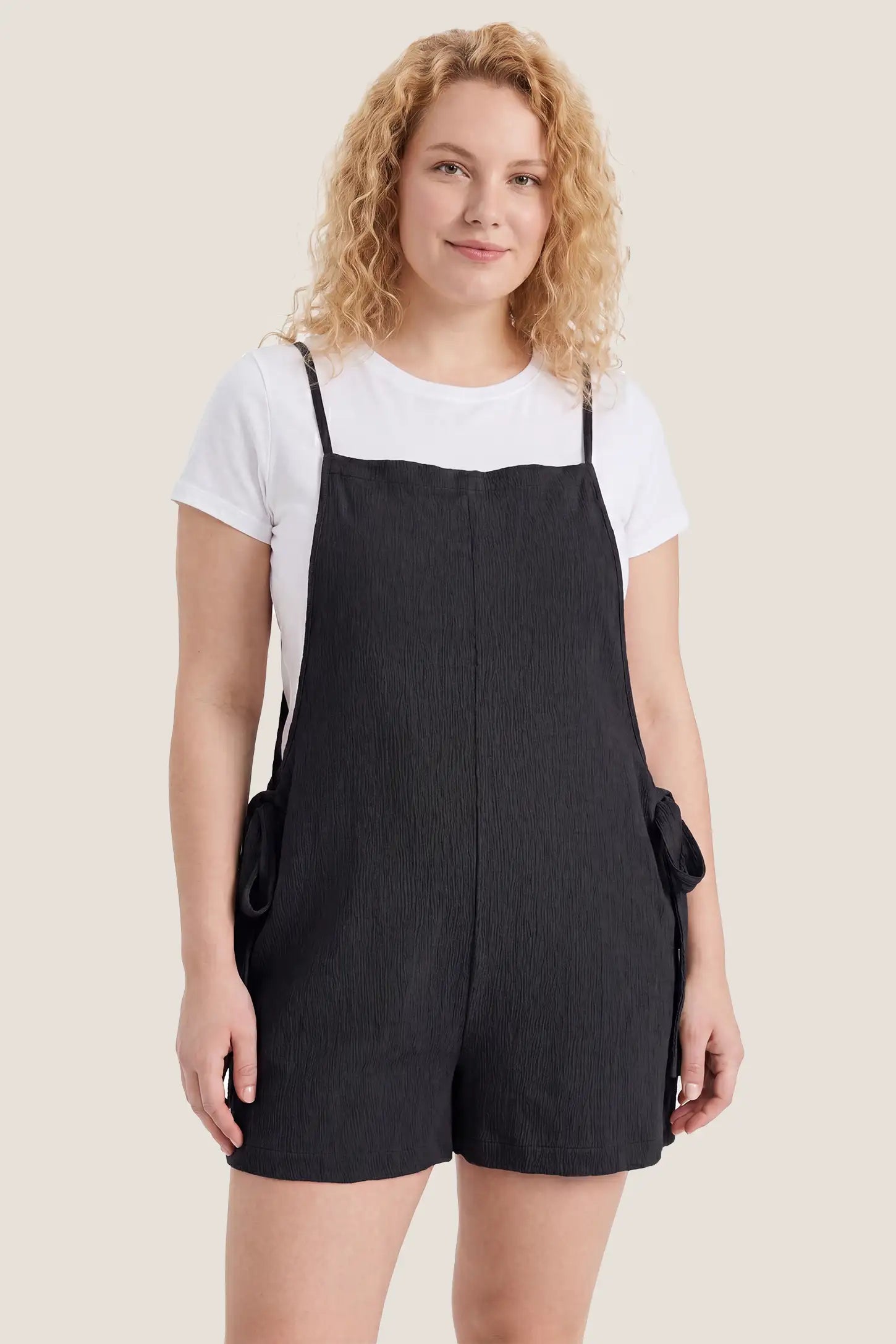Spaghetti Strap Tie-Side Maternity Romper Studio view of the black Spaghetti Strap Tie-Side Maternity Romper showing the relaxed fit and minimalist design.