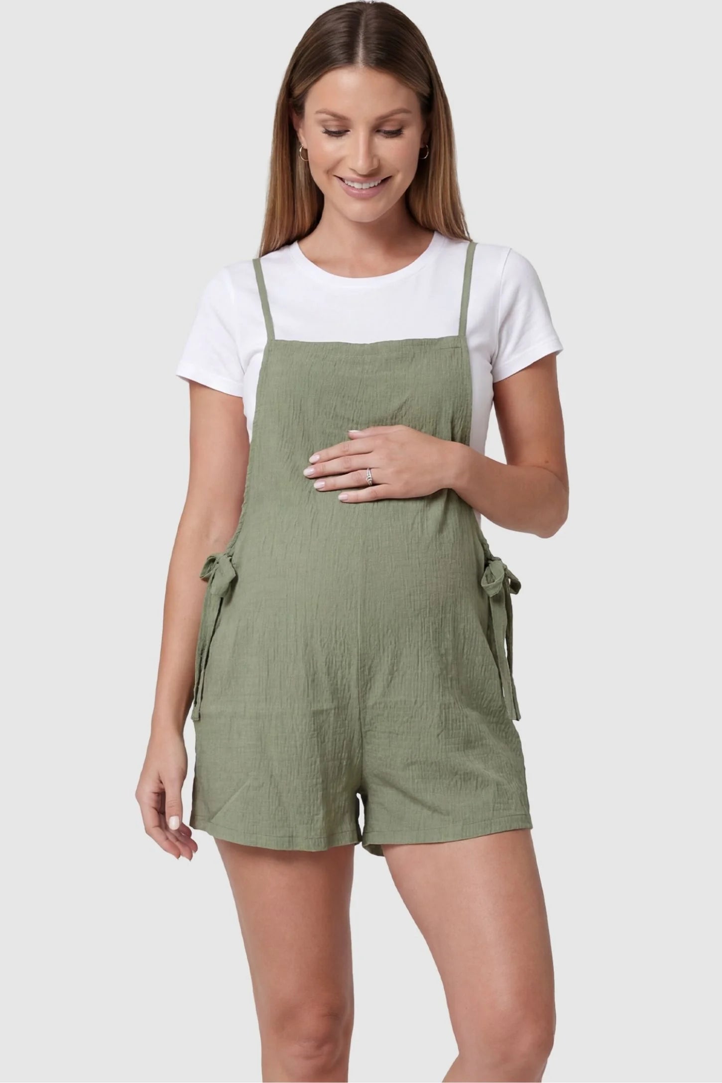Spaghetti Strap Tie-Side Maternity Romper in Green featuring a square neckline on a front-facing pregnant model.