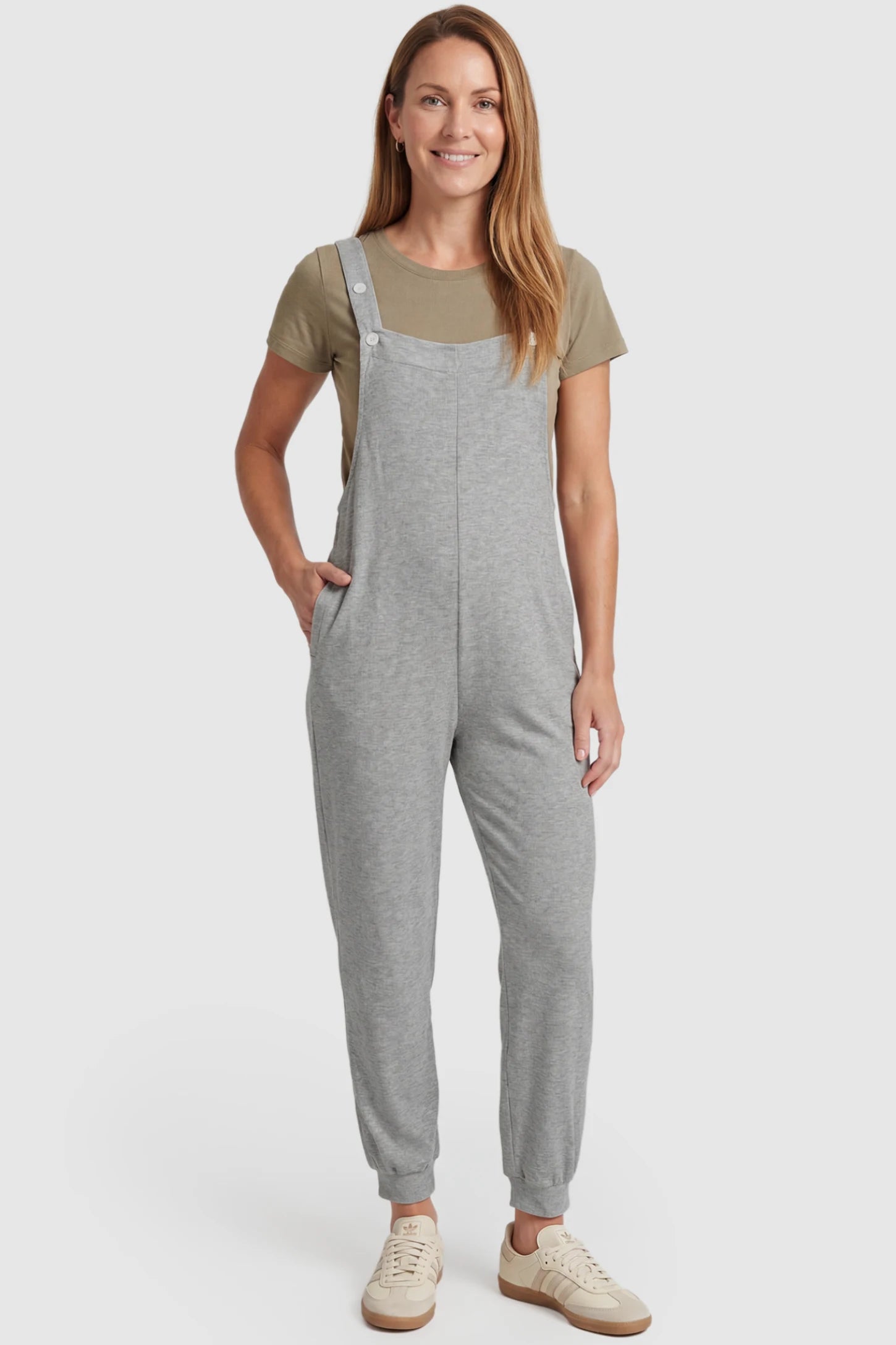 Square Neck Pocketed Maternity Jogger Jumpsuit Square Neck Pocketed Maternity Jogger Jumpsuit in gray featuring button straps on a postpartum model, front view.