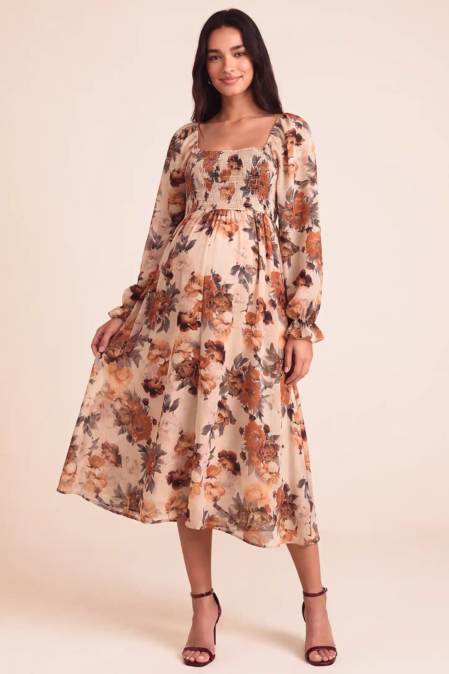 Square Neck Smocked Floral Maternity Midi Dress Square Neck Smocked Floral Maternity Midi Dress in Rust Floral with stretchy smocked chest and A-line drape on a pregnant model, studio front view.