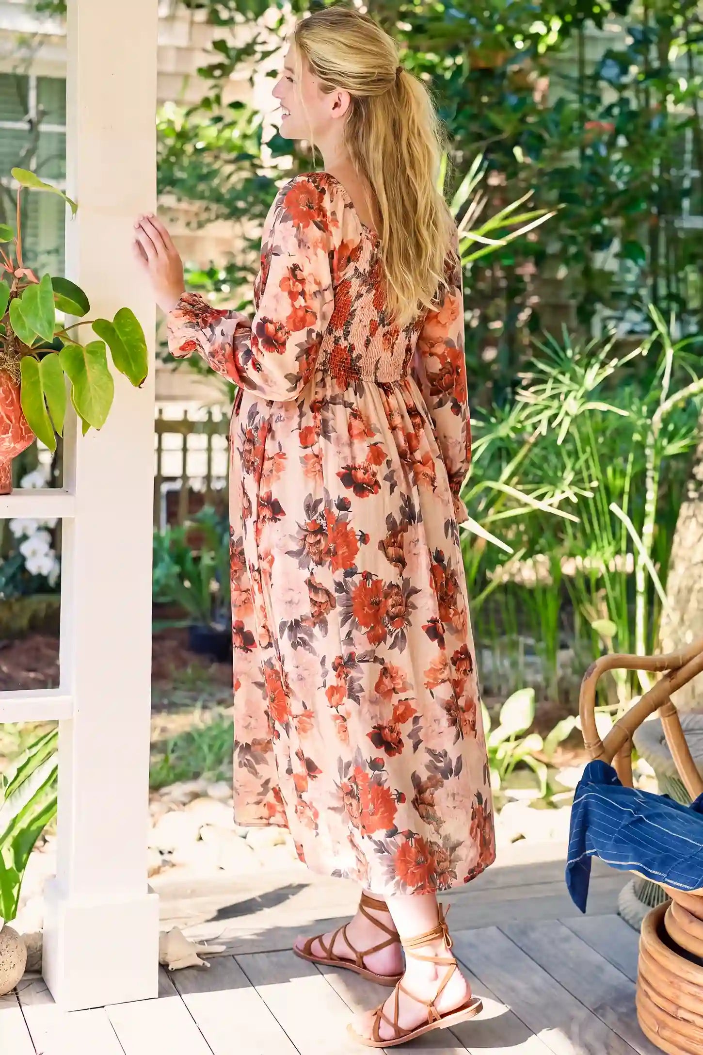 Square Neck Smocked Floral Maternity Midi Dress Square Neck Smocked Floral Maternity Midi Dress in Rust Floral featuring an A-line hem and long sleeves on a pregnant model, lifestyle back view.