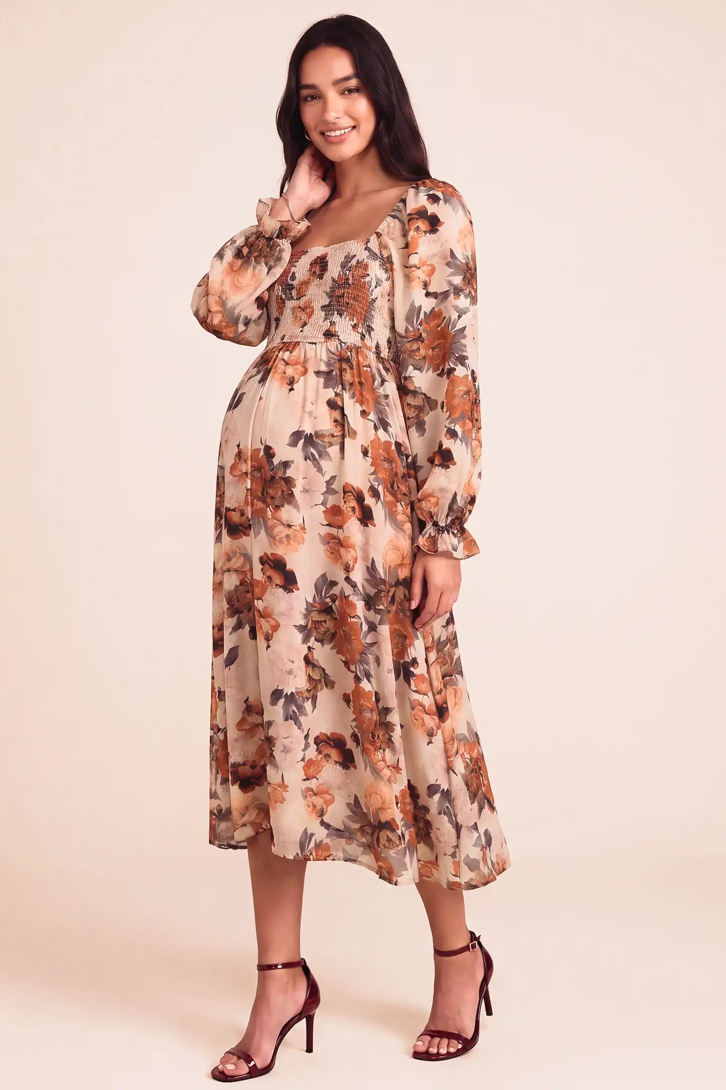 Square Neck Smocked Floral Maternity Midi Dress Square Neck Smocked Floral Maternity Midi Dress in Rust Floral showing comfortable bump fit on a pregnant model, studio side view.