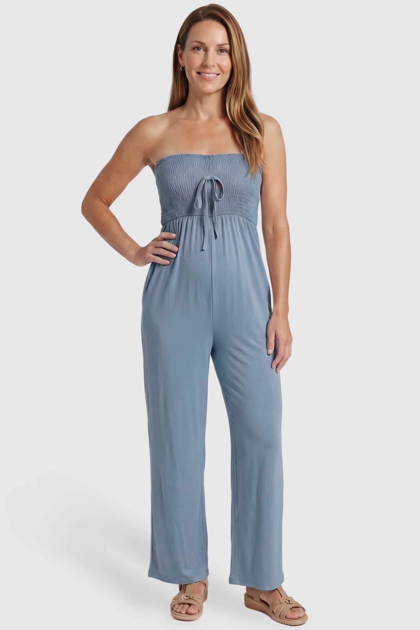 Strapless Smocked Bust Wide Leg Maternity Jumpsuit Strapless Smocked Bust Wide Leg Maternity Jumpsuit in Blue featuring a relaxed leg design on a postpartum model, front view.