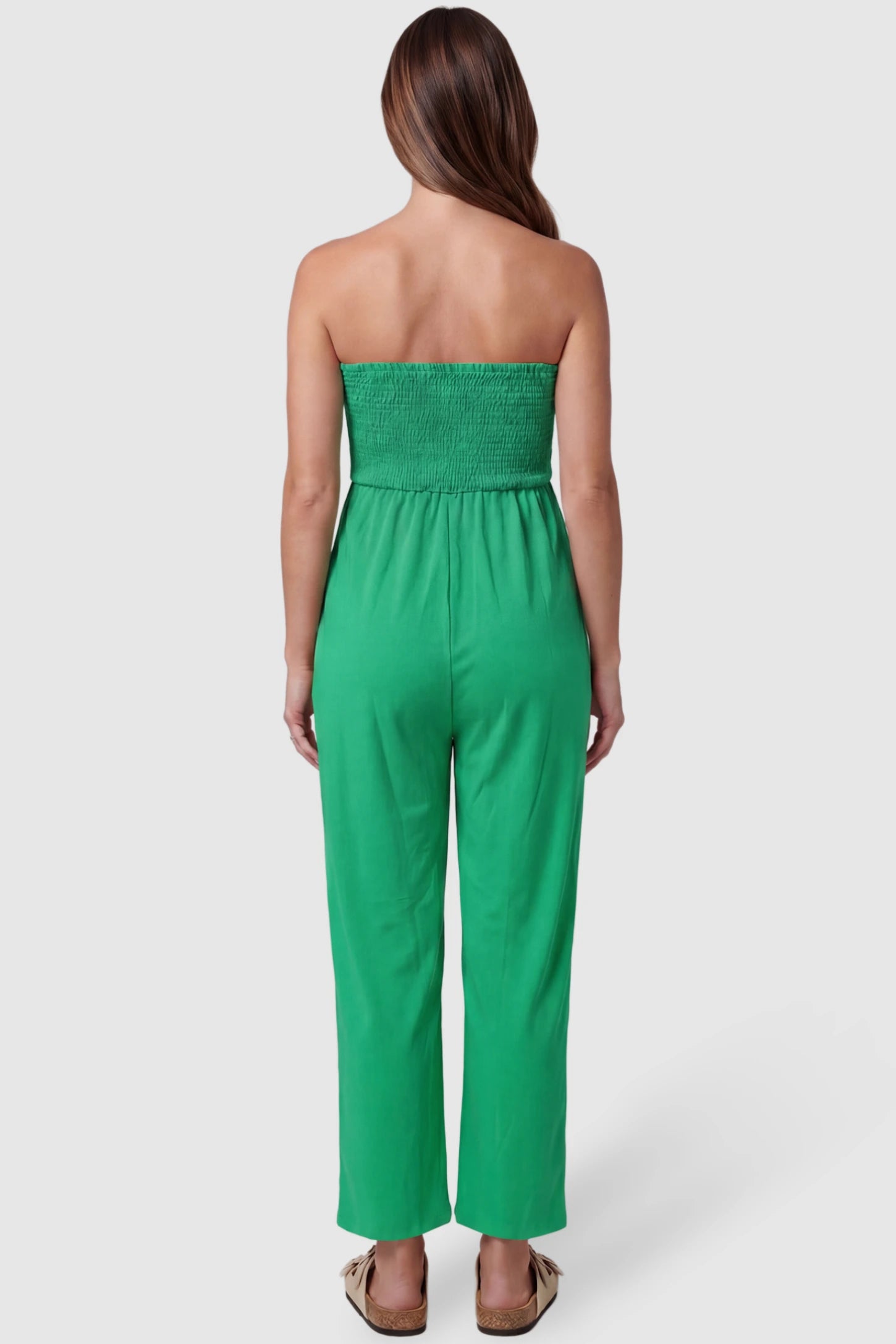 Strapless Smocked Bust Wide Leg Maternity Jumpsuit Strapless Smocked Bust Wide Leg Maternity Jumpsuit in Green featuring a relaxed leg design on a pregnant model, back view.