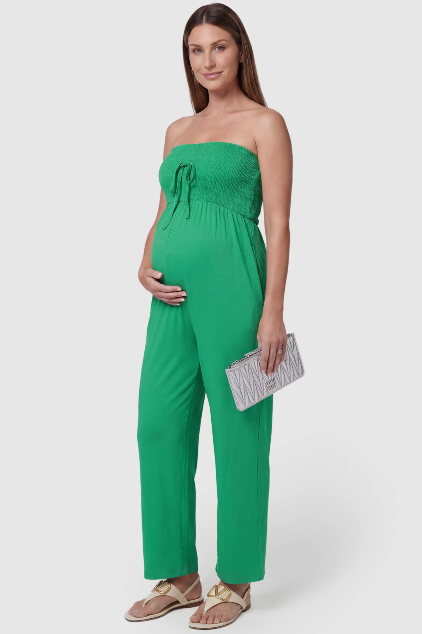 Strapless Smocked Bust Wide Leg Maternity Jumpsuit Strapless Smocked Bust Wide Leg Maternity Jumpsuit in Green featuring a relaxed leg design on a pregnant model, side view.