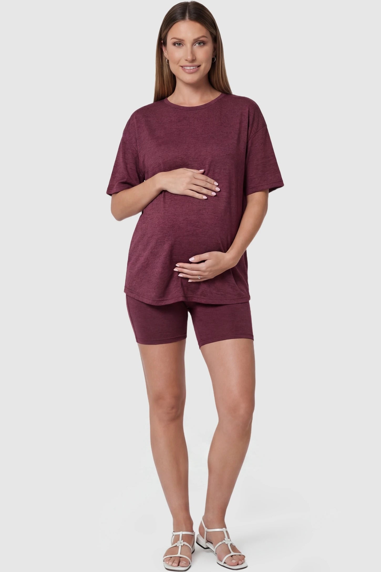 Stretch Oversized Tee & Biker Short Maternity Lounge Set in burgundy featuring a relaxed fit tee and high-stretch shorts on a pregnant model, front view.