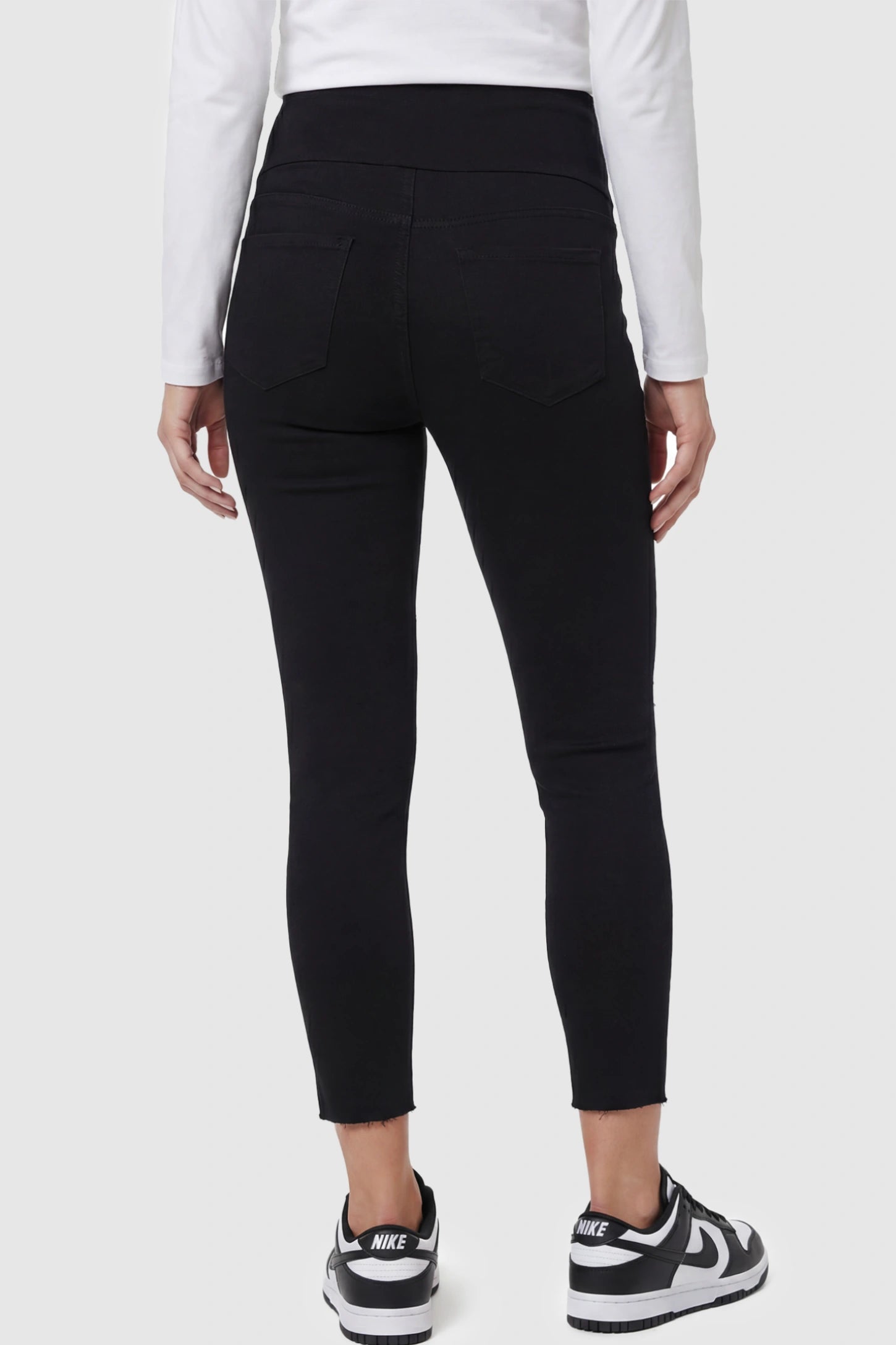 Stretch Panel Distressed Skinny Maternity Jeans Stretch Panel Distressed Skinny Maternity Jeans in Black featuring skinny leg on a pregnant model back view.