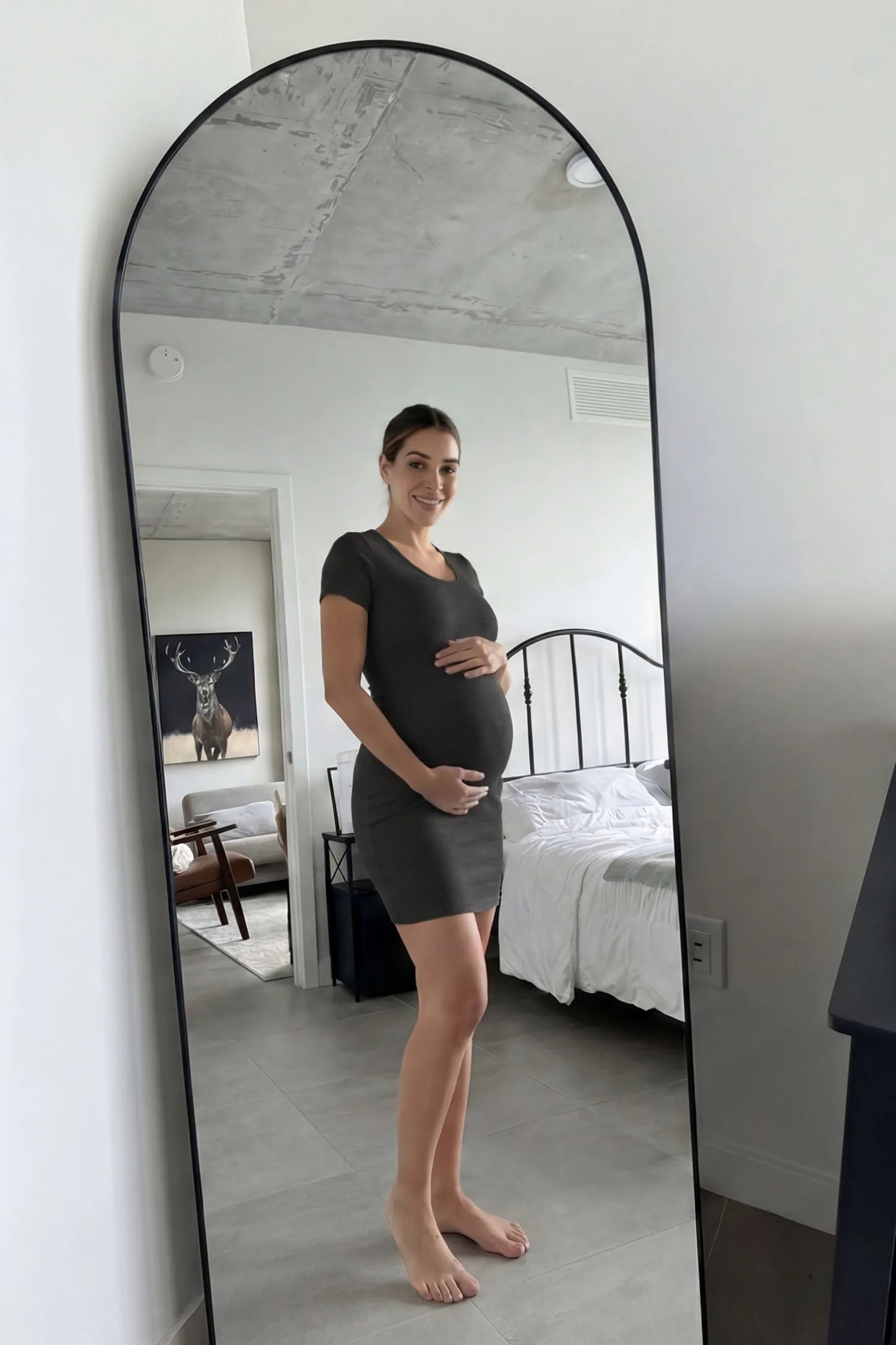 Stretchy Ribbed Short Sleeve Maternity Bodycon Dress UGC: Stretchy Ribbed Short Sleeve Maternity Bodycon Dress in Dark Grey featuring a stretchy V-neck ribbed design on a pregnant model, mirror selfie UGC view.