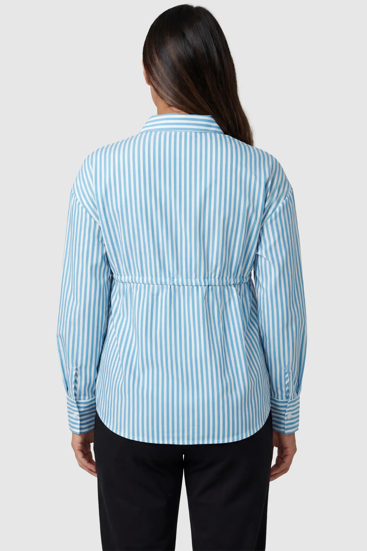Striped Button Down Collared Neck Maternity Top Striped Button Down Collared Neck Maternity Top in Blue featuring longline hem, and gathered waist on a pregnant model, back view.