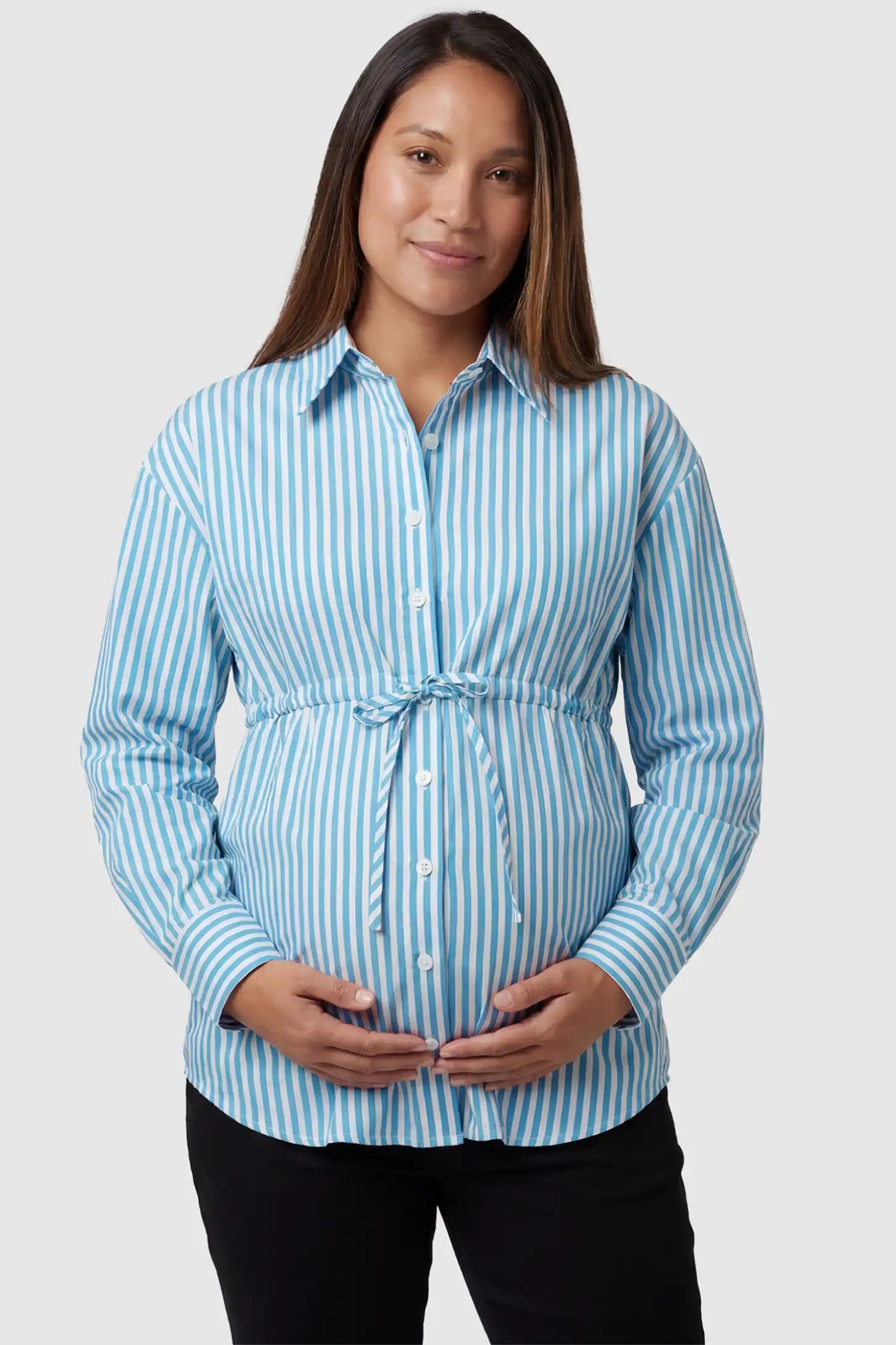 Striped Button Down Collared Neck Maternity Top Striped Button Down Collared Neck Maternity Top in Blue featuring a mid-waist adjustable drawstring on a pregnant model, front view.