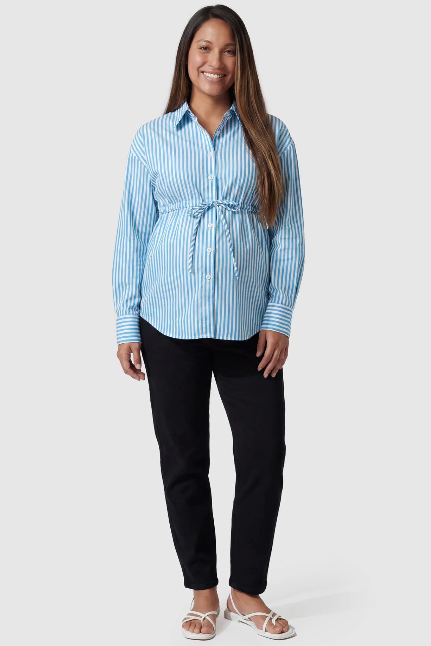 Striped Button Down Collared Neck Maternity Top Striped Button Down Collared Neck Maternity Top in Blue featuring a mid-waist adjustable drawstring on a pregnant model, full body view.