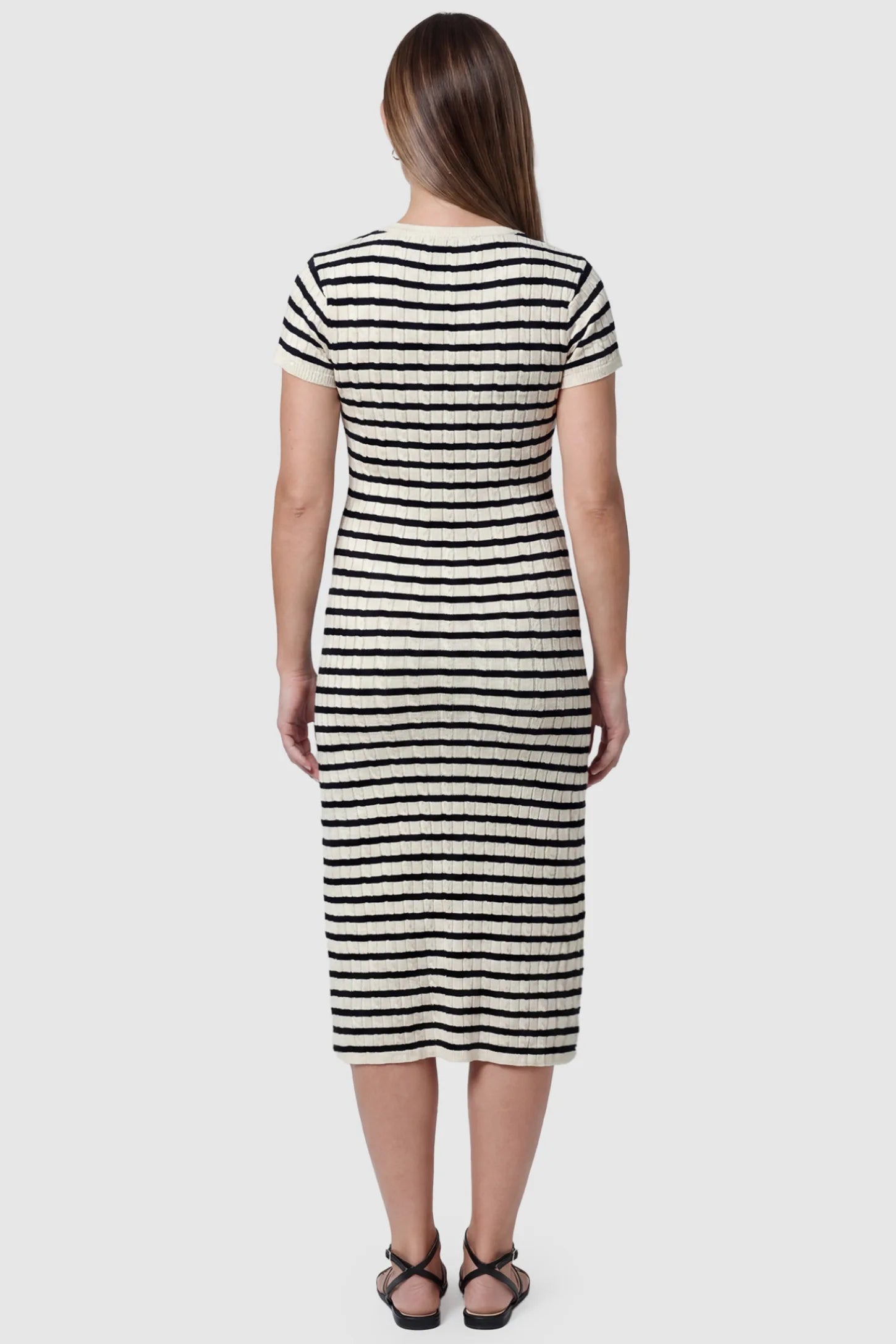Striped Button Front Short Sleeve Maternity Midi Dress Striped Button Front Short Sleeve Maternity Midi Dress in black stripe featuring short sleeves and soft knit high stretch fabric on a pregnant model, back view.