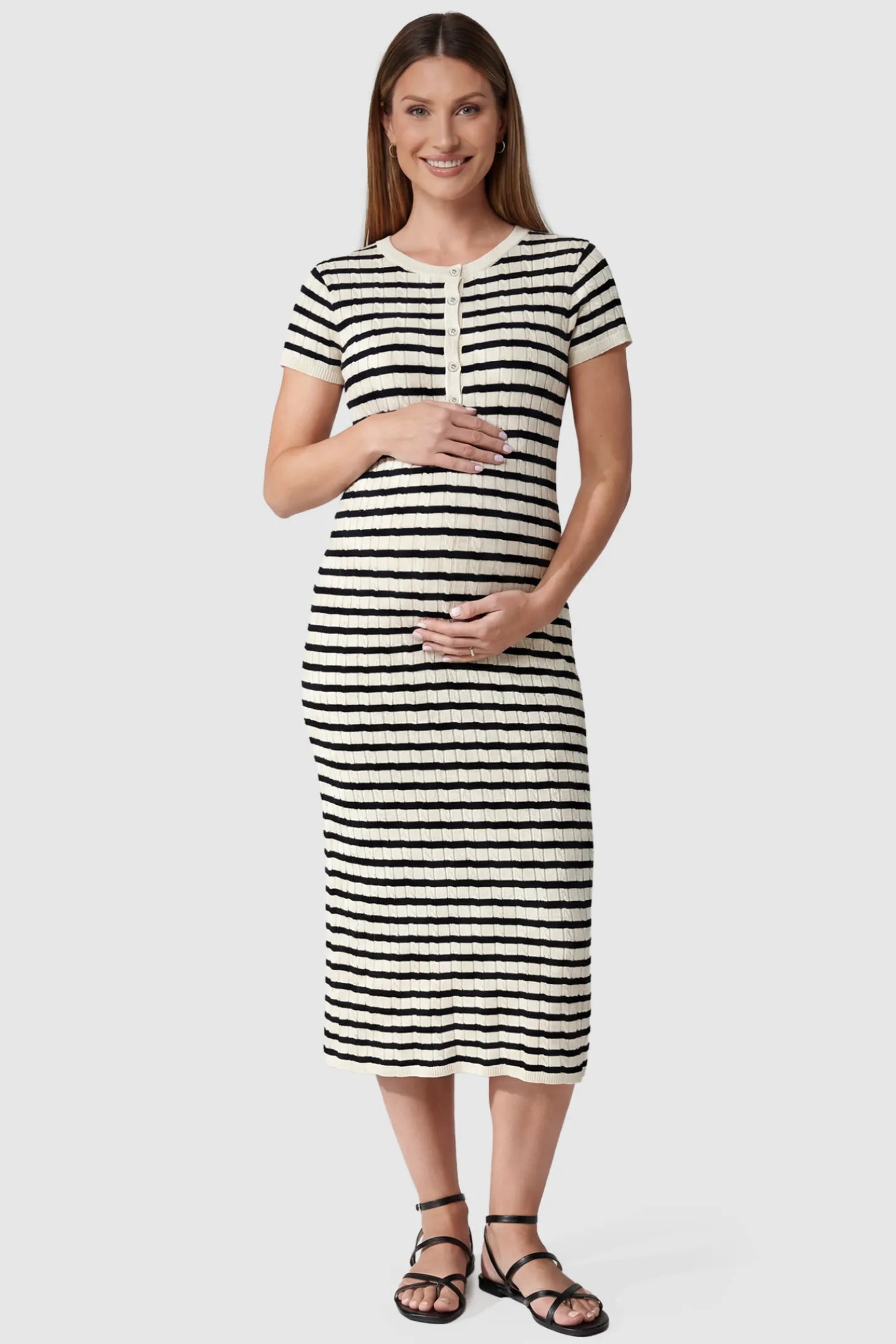 Striped Button Front Short Sleeve Maternity Midi Dress Striped Button Front Short Sleeve Maternity Midi Dress in black stripe featuring short sleeves and a round neck on a pregnant model, front view.