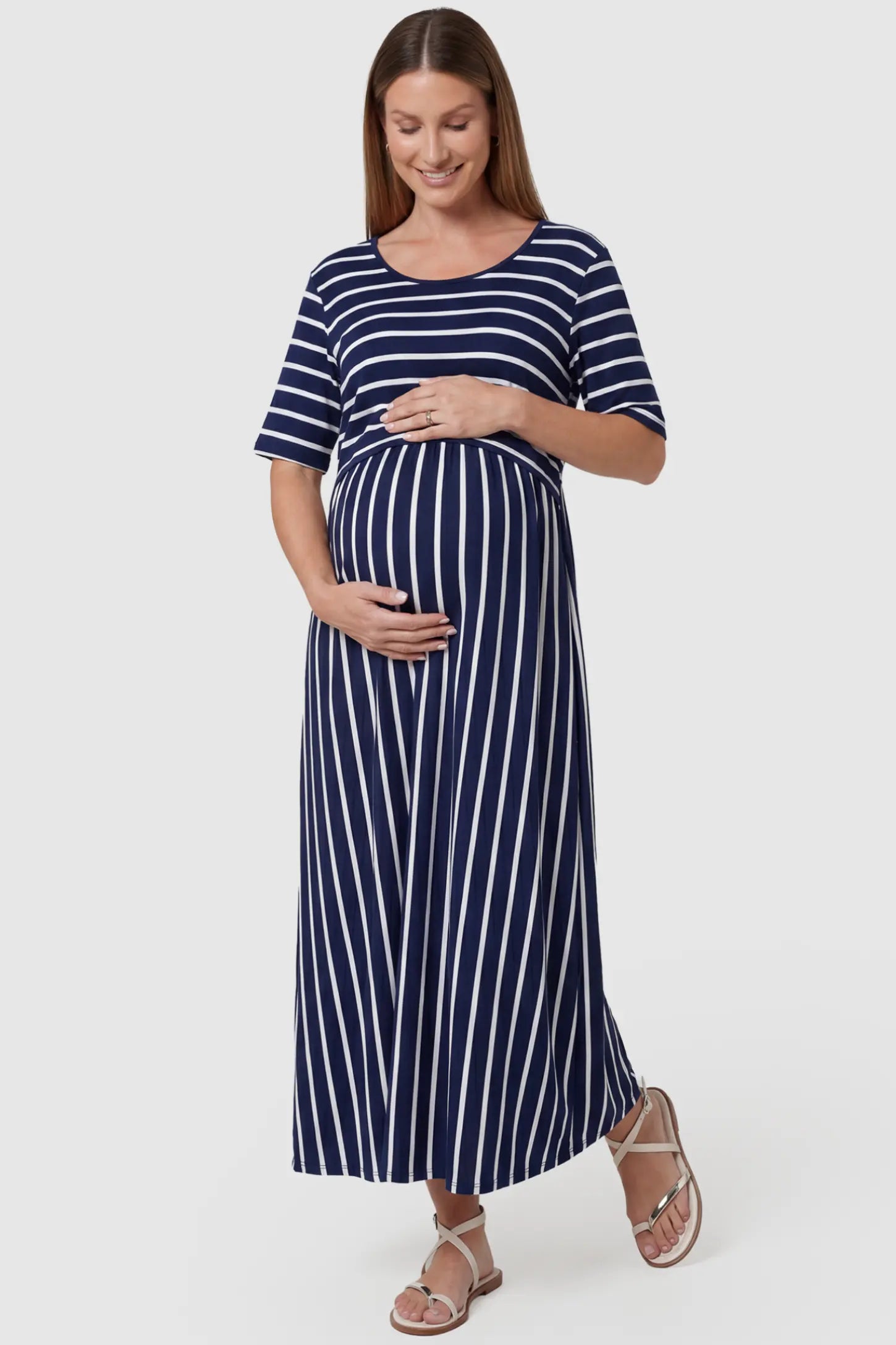 Stretch Jersey Mixed-Stripe Maternity Maxi Dress in dark blue and White featuring an empire waist on a pregnant model, front view.