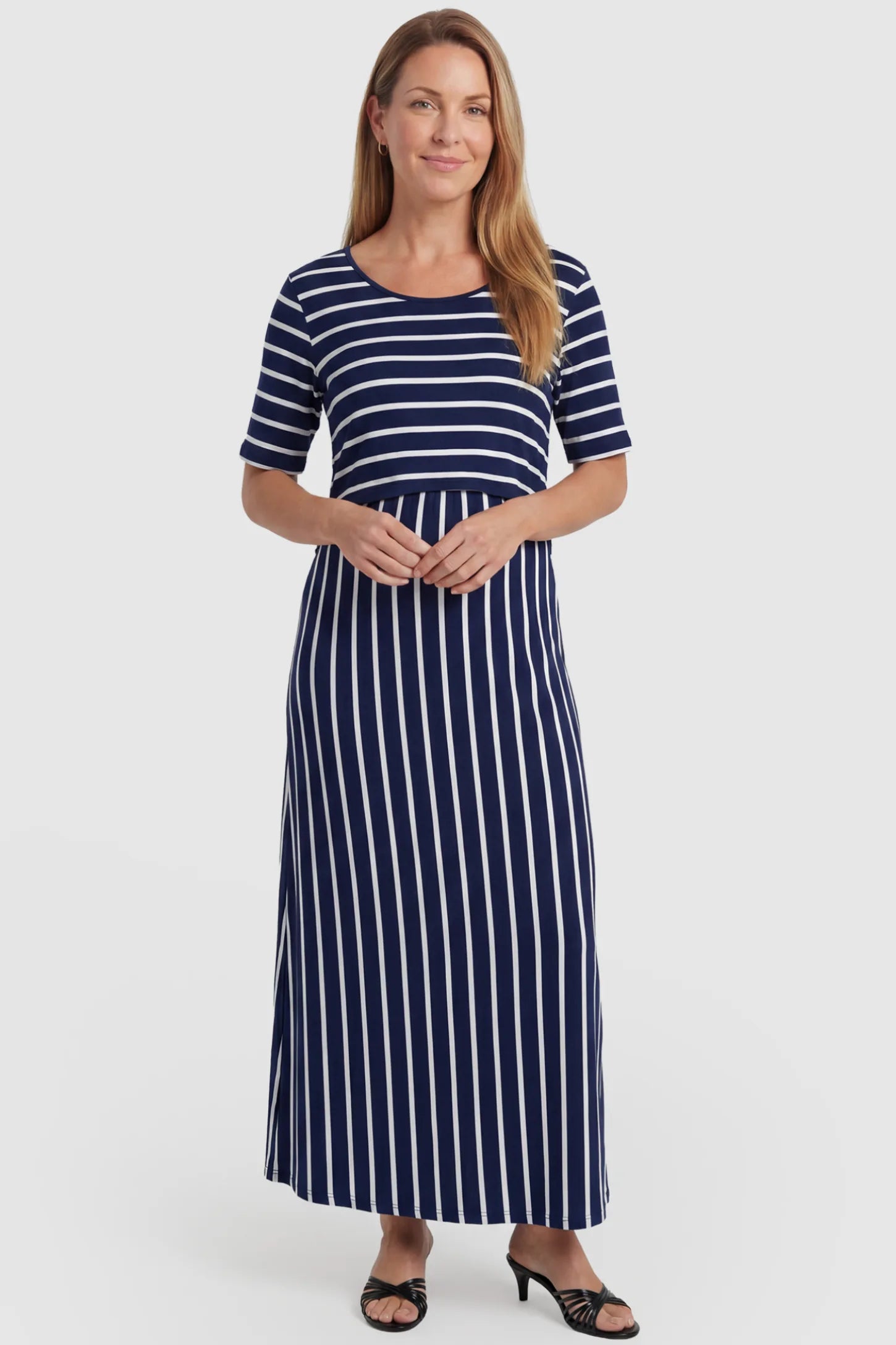 Striped Long Sleeve Maternity Maxi Dress Stretch Jersey Mixed-Stripe Maternity Maxi Dress in dark blue and White featuring an empire waist on a postpartum model, front view.