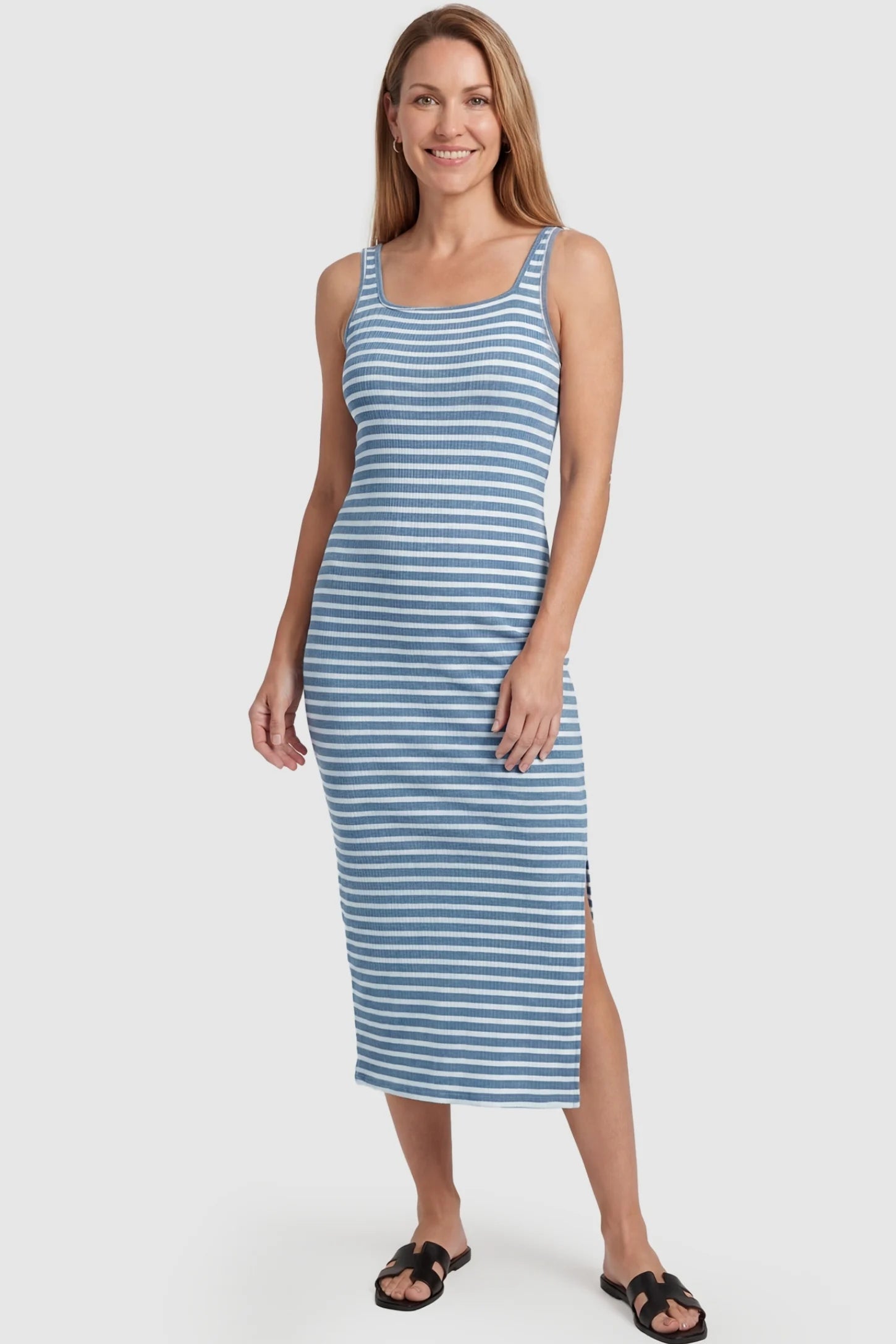 Striped Ribbed Sleeveless Maternity Midi Dress Striped Ribbed Sleeveless Maternity Midi Dress in Blue featuring a flexible striped fabric on a non-pregnant model, postpartum view.