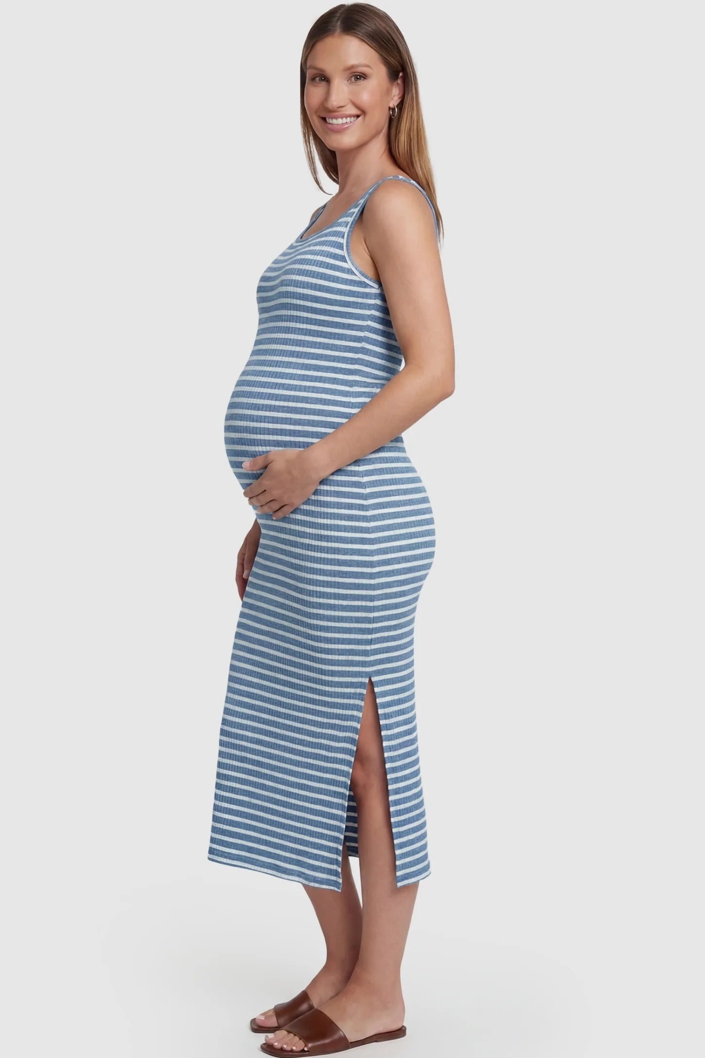 Striped Ribbed Sleeveless Maternity Midi Dress Striped Ribbed Sleeveless Maternity Midi Dress in Blue featuring a streamlined sleeveless design on a pregnant model, side view.