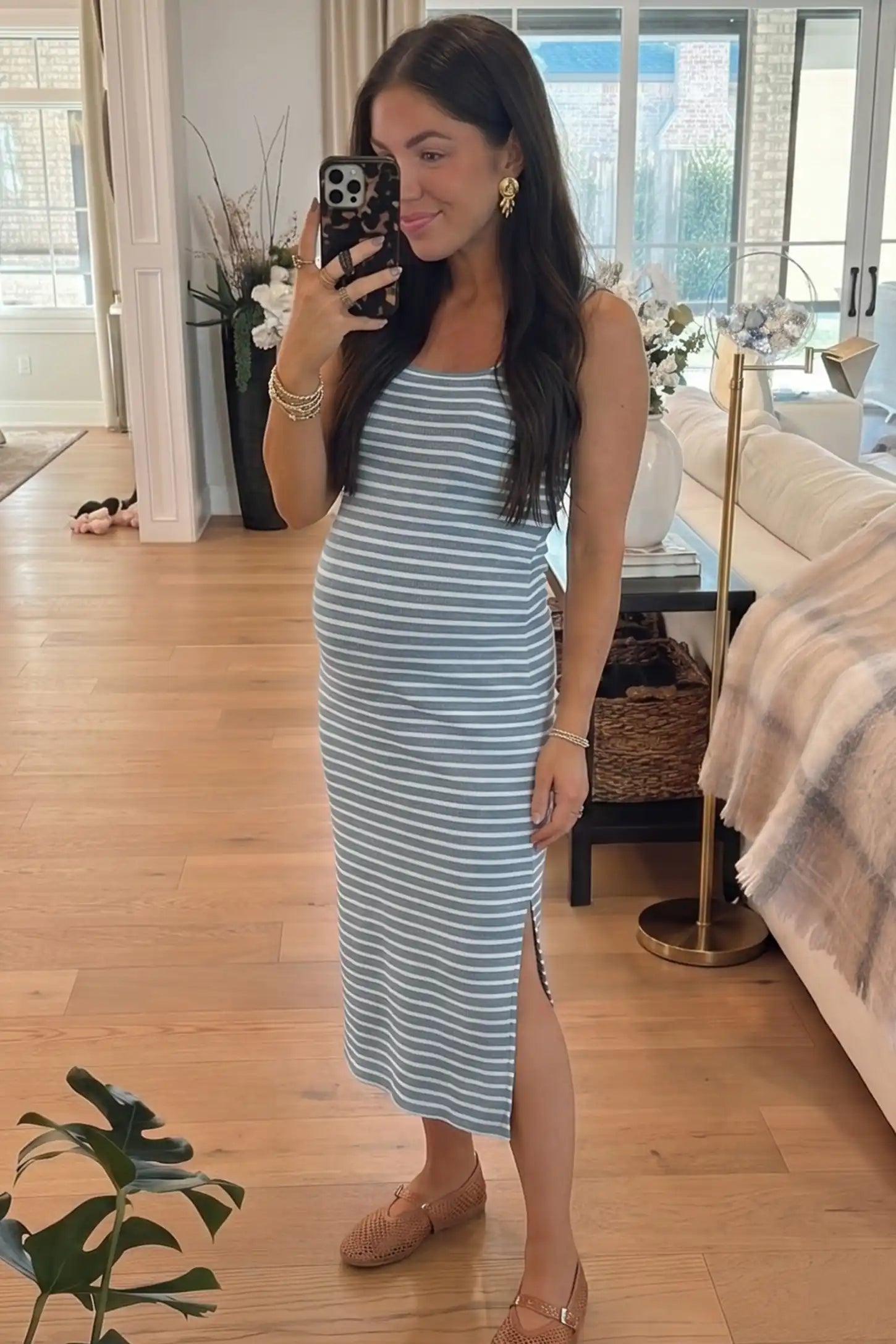 Striped Ribbed Sleeveless Maternity Midi Dress Striped Ribbed Sleeveless Maternity Midi Dress in Blue featuring classic nautical-inspired stripes on a pregnant model in a mirror selfie, UGC view.