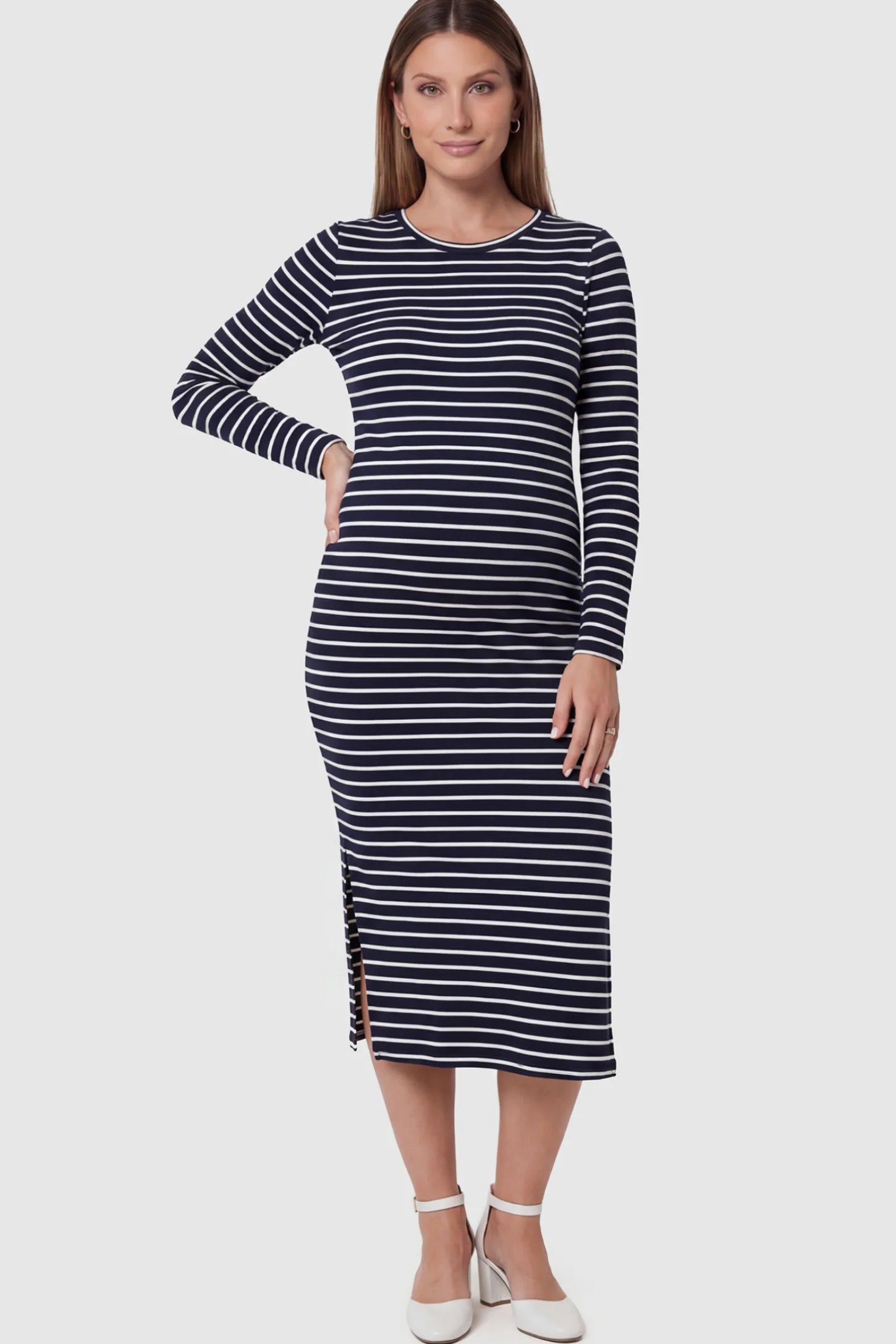 Striped Side Slit Long Sleeve Bodycon Maternity Midi Dress Striped side slit long sleeve bodycon maternity midi dress in black and white featuring a bump-flattering fit on a pregnant model showing front.