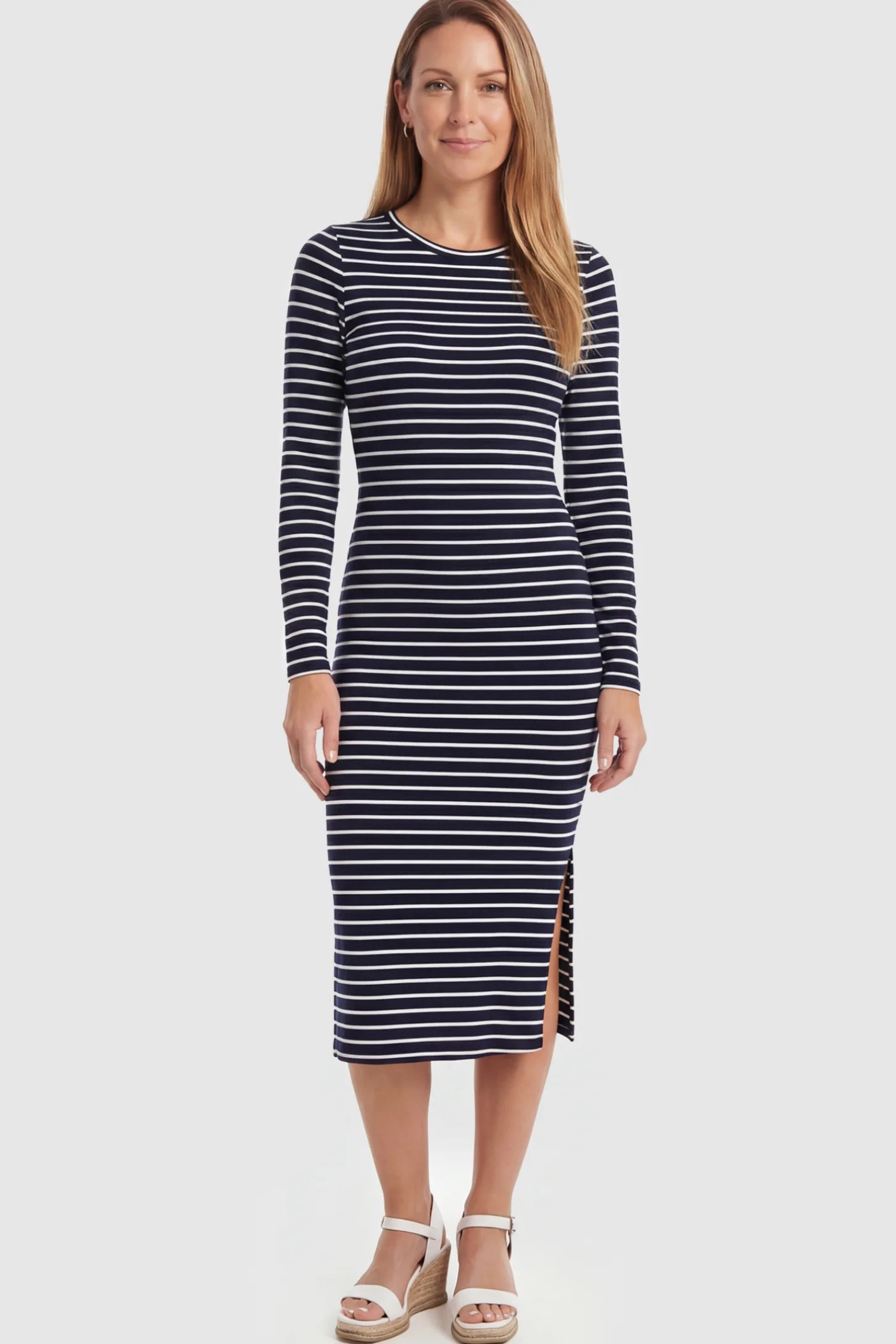 Striped Side Slit Long Sleeve Bodycon Maternity Midi Dress Striped side slit long sleeve bodycon maternity midi dress in black and white featuring a bump-flattering fit on a postpartum model showing front.