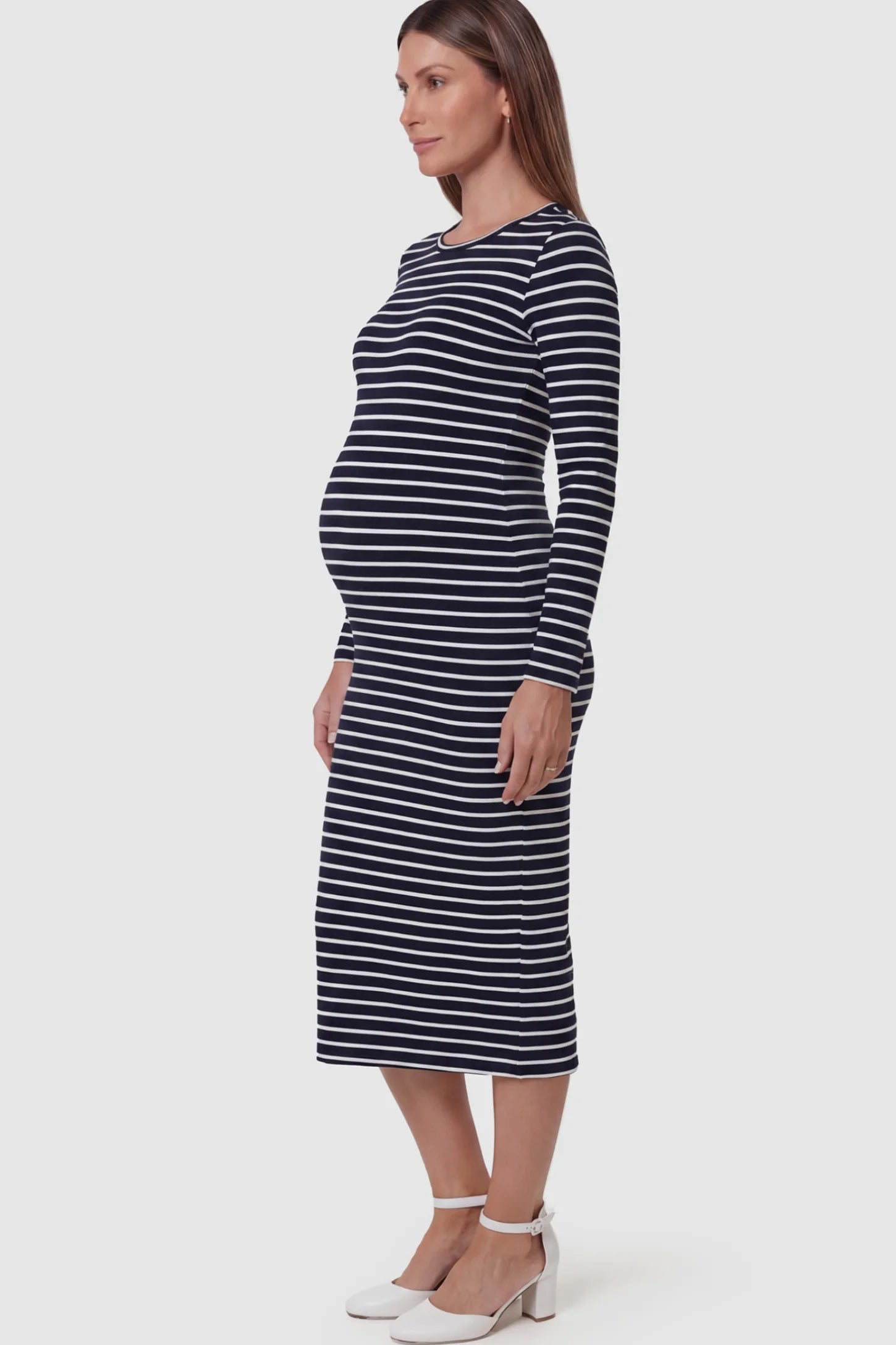 Striped Side Slit Long Sleeve Bodycon Maternity Midi Dress Striped side slit long sleeve bodycon maternity midi dress in black and white featuring a bump-flattering fit on a pregnant model showing side.