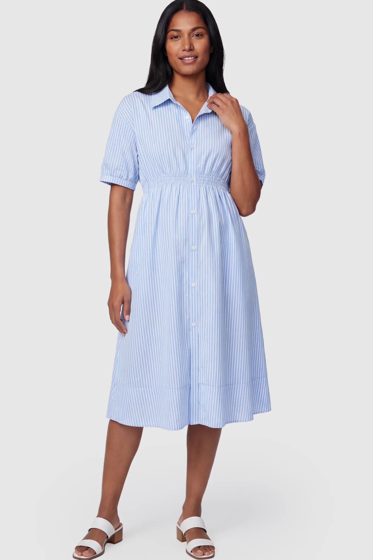 Striped Smocked Waist Button Down Maternity Shirt Dress Striped Smocked-Waist Button-Down Maternity Shirt Dress in light blue and white stripes featuring a collared neckline and short sleeves on a postpartum model showing front.
