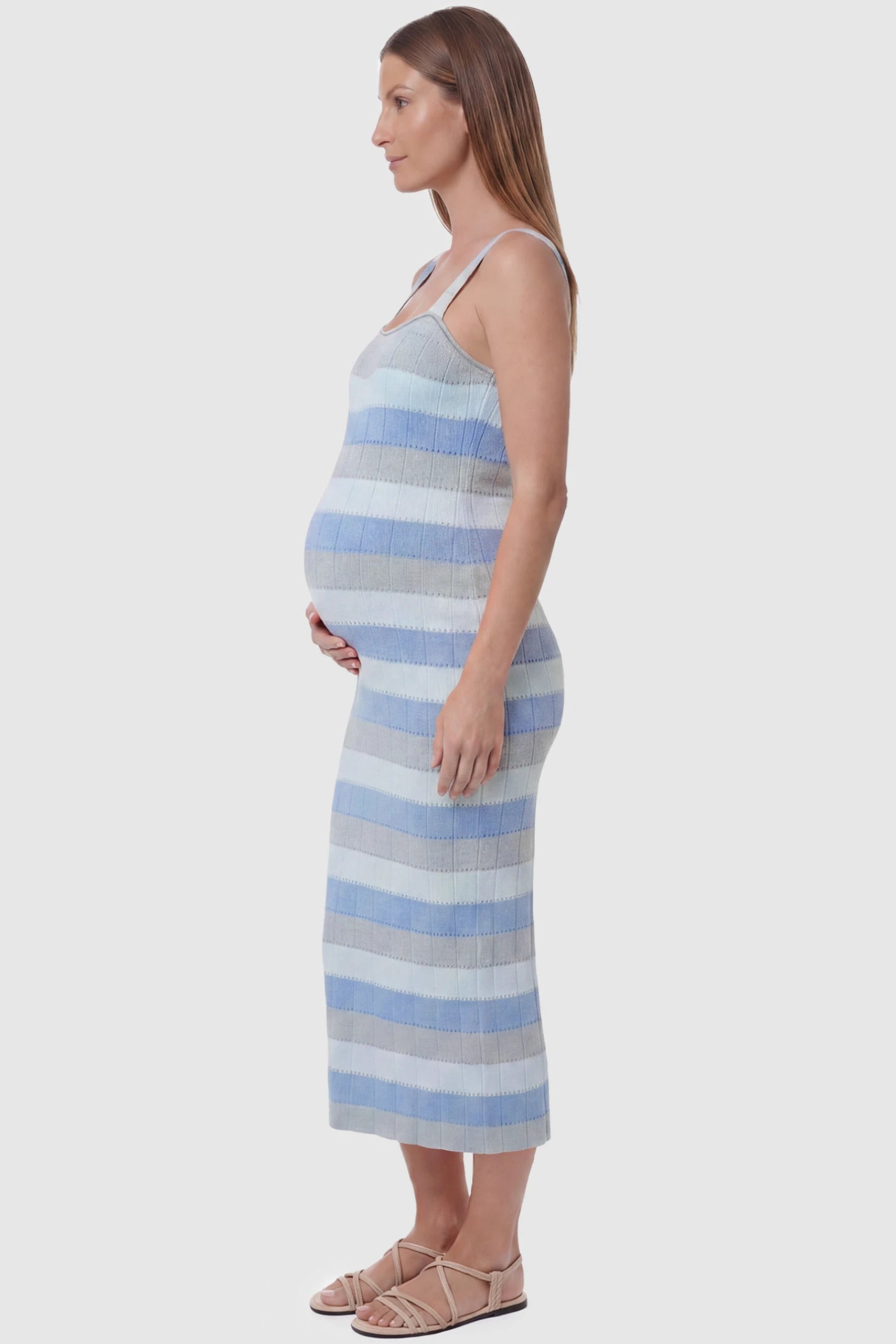 Striped Square Neck Sleeveless Maternity Midi Dress Striped Square Neck Sleeveless Maternity Midi Dress in Blue featuring adjustable slider straps and soft knit stretch on a pregnant model, side view.