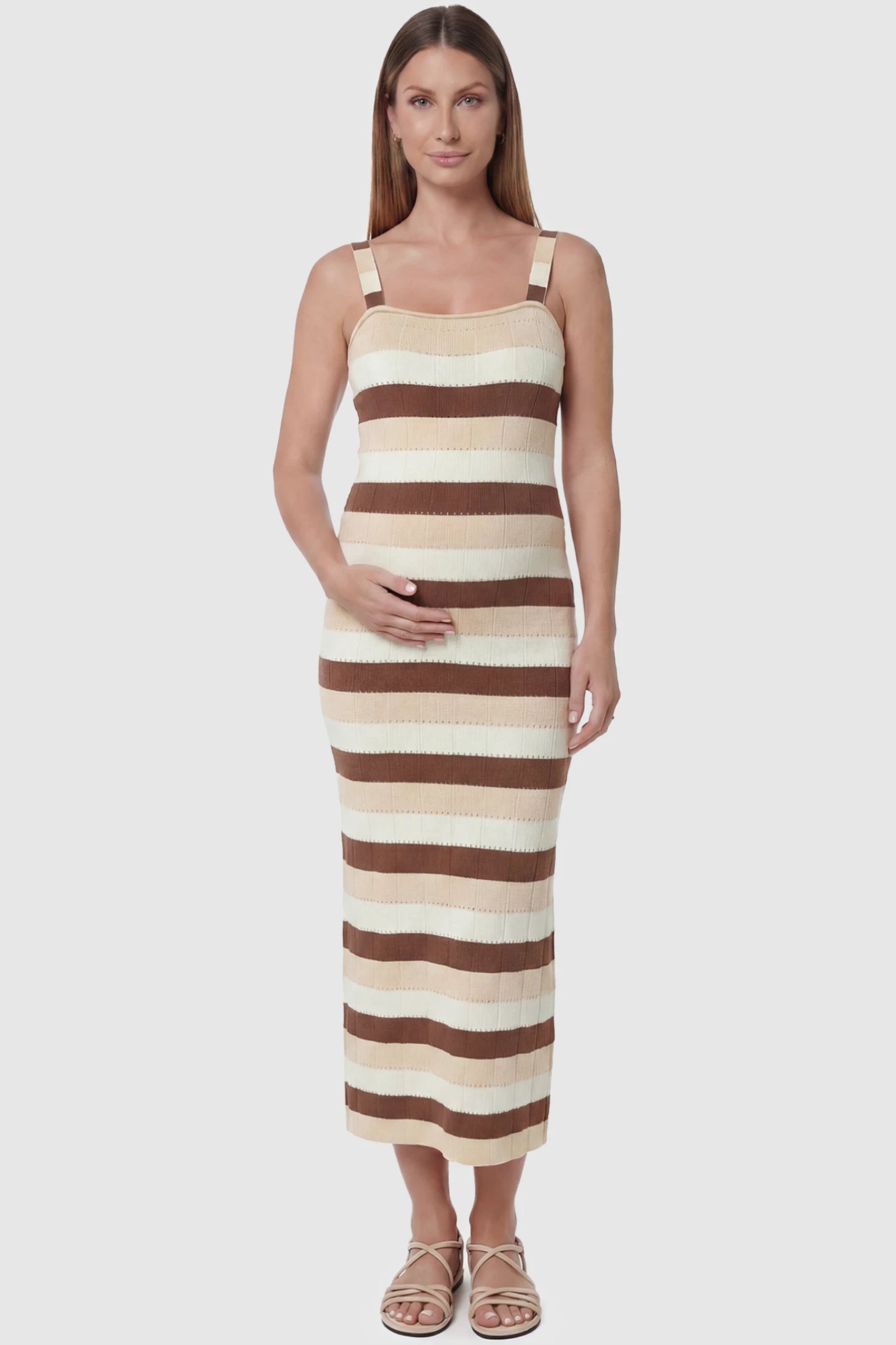 Striped Square Neck Sleeveless Maternity Midi Dress Striped Square Neck Sleeveless Maternity Midi Dress in Brown featuring adjustable slider straps and soft knit stretch on a pregnant model, front view.