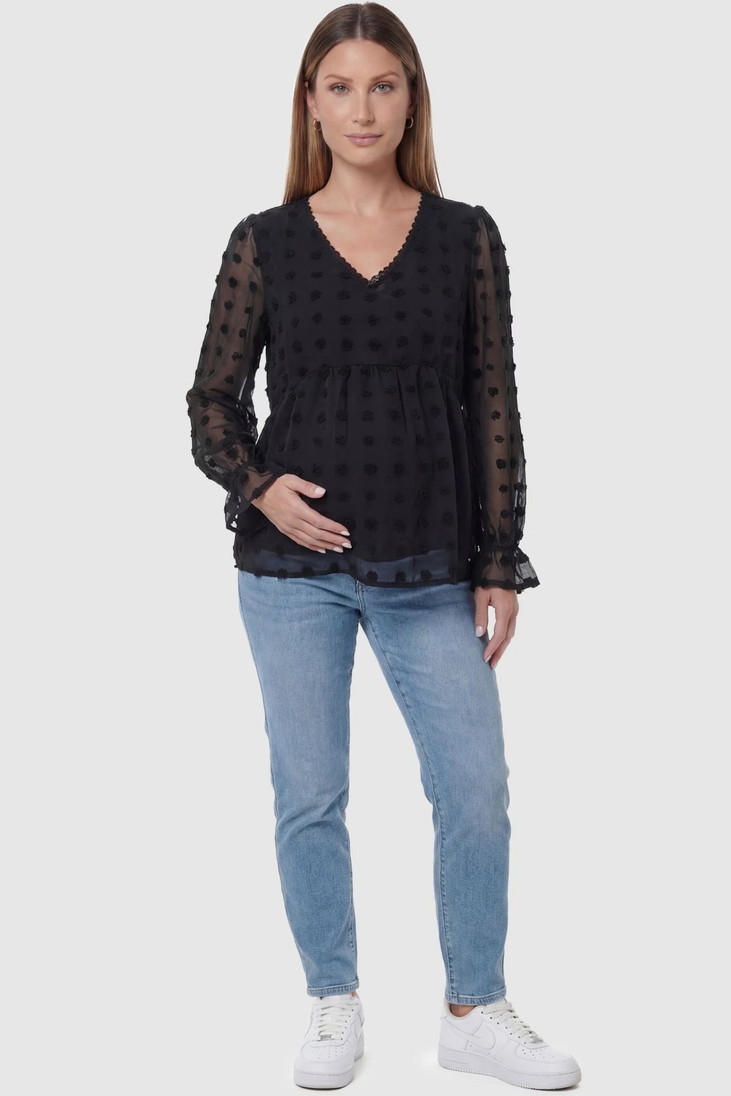 Swiss Dot Sheer Empire Waist Maternity Top Swiss Dot Sheer Empire Waist Maternity Top in black featuring textured swiss dots, front view on a pregnant model.