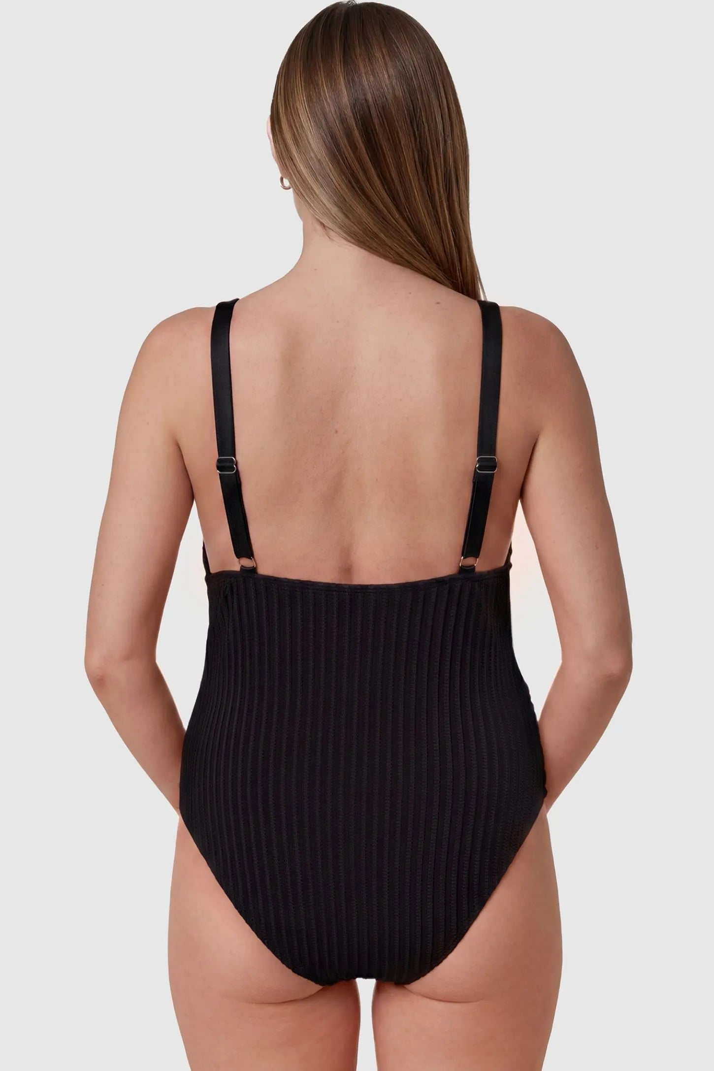 Textured Curve-Hugging Maternity One Piece Swimsuit Textured Curve-Hugging One Piece Swimsuit in Black featuring stretchy ribbed fabric on a pregnant model, back view.