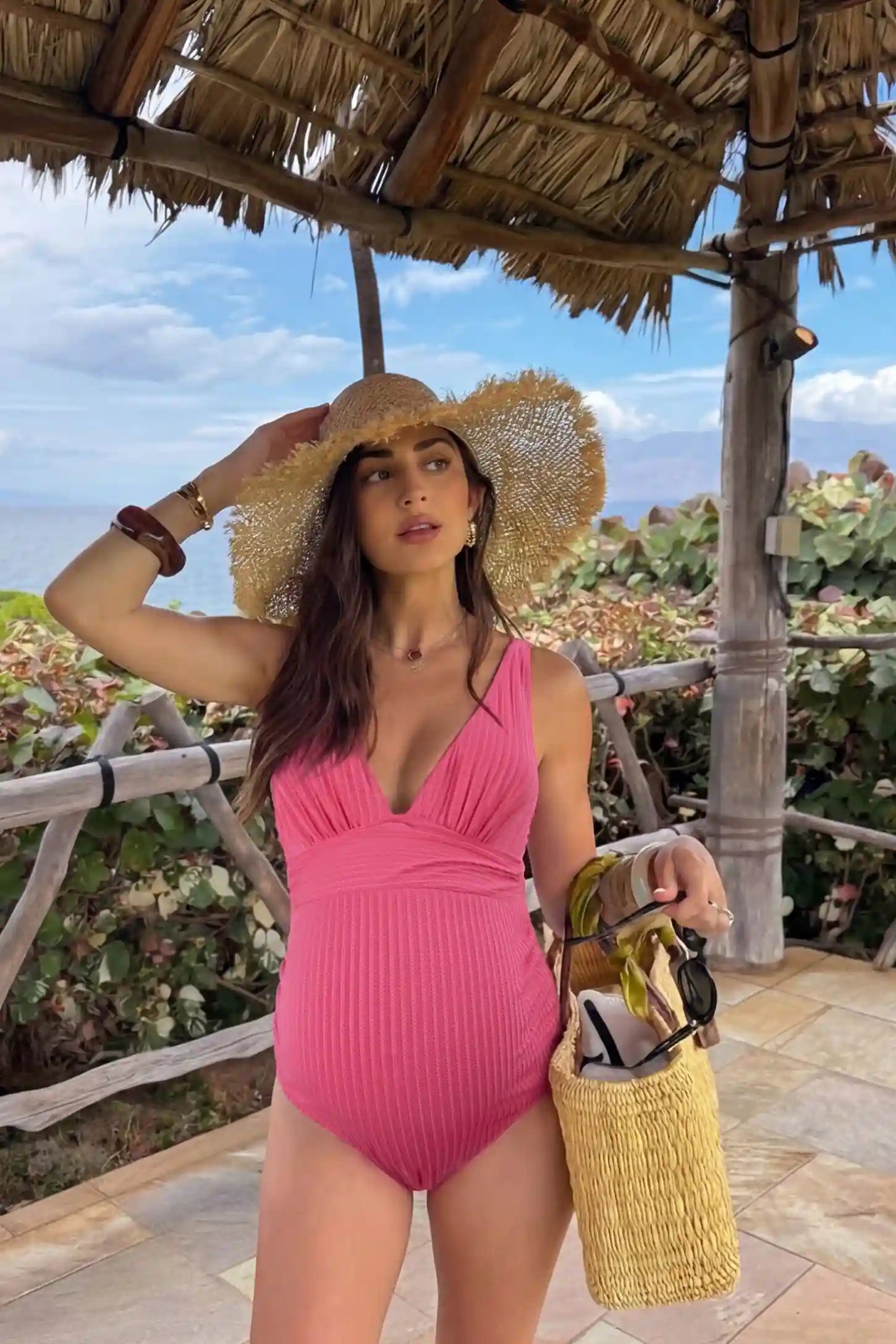 Textured Curve-Hugging Maternity One Piece Swimsuit Textured Curve-Hugging One Piece Swimsuit in Pink featuring a subtle ribbed pattern on a pregnant model, UGC view.