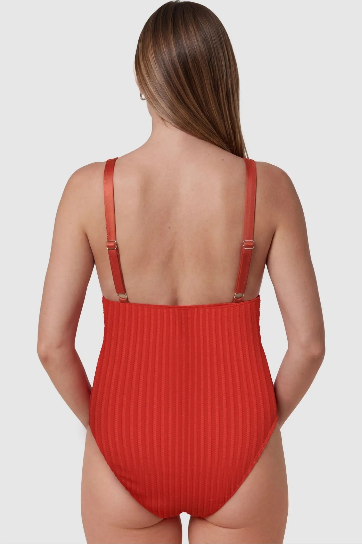 Textured Curve-Hugging Maternity One Piece Swimsuit Textured Curve-Hugging One Piece Swimsuit in Watermelon Red featuring stretchy ribbed fabric on a pregnant model, back view.