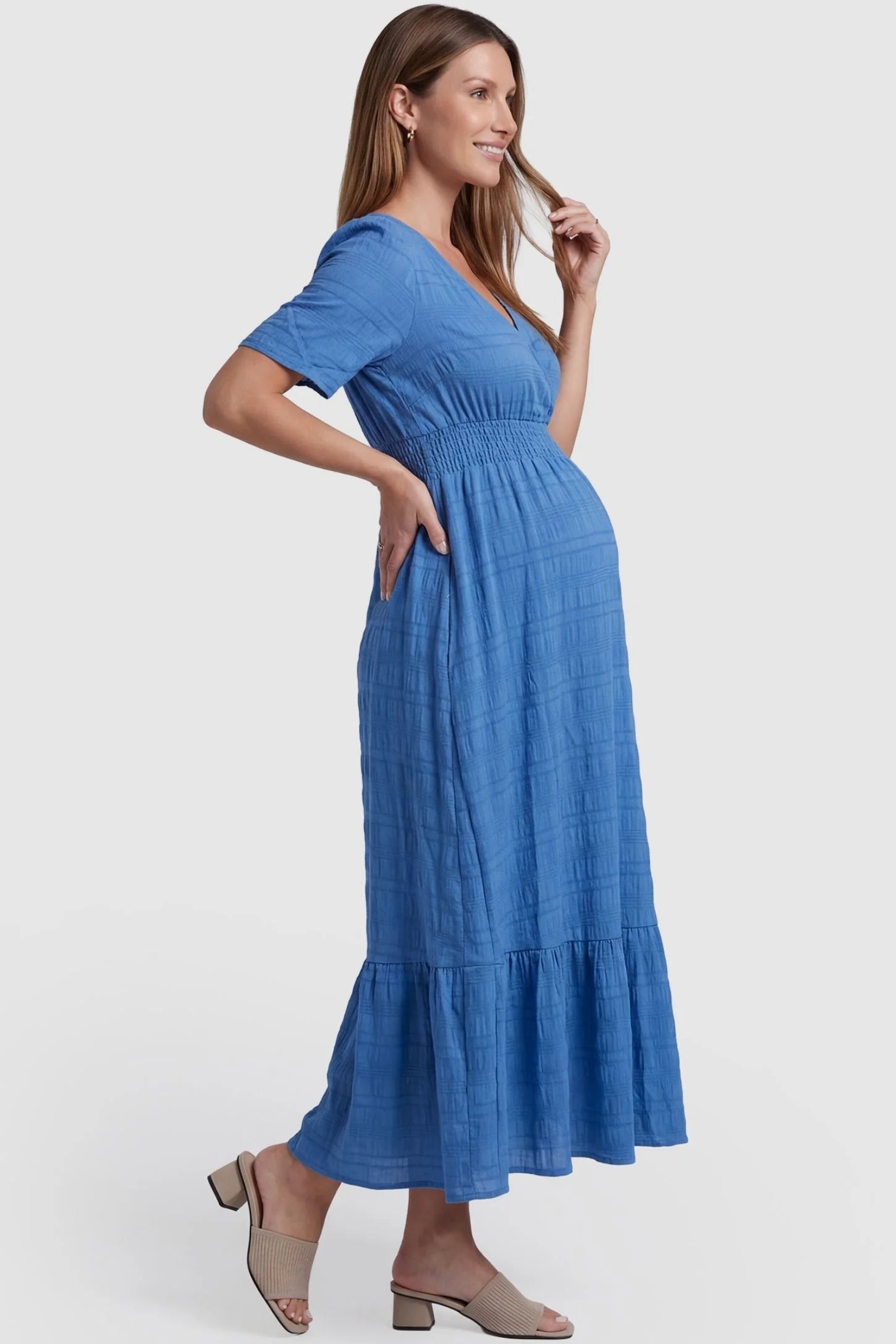 Textured Knit Butterfly Sleeve Maternity Midi Dress Textured Knit Butterfly Sleeve Midi Dress in Blue featuring feminine short butterfly sleeves on a pregnant model, side view.