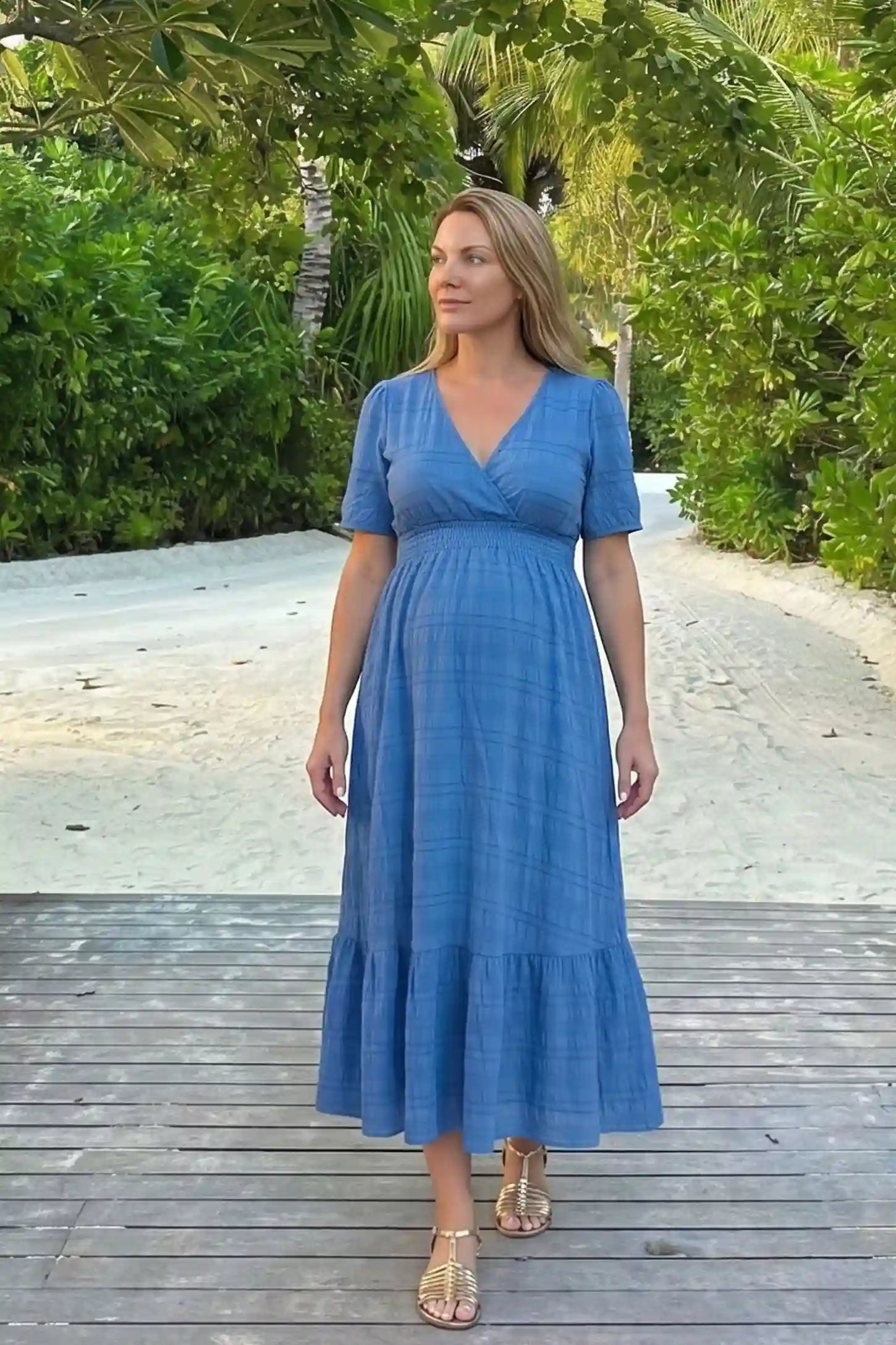 Textured Knit Butterfly Sleeve Maternity Midi Dress Textured Knit Butterfly Sleeve Midi Dress in Blue featuring feminine short butterfly sleeves on a pregnant model, UGC view.