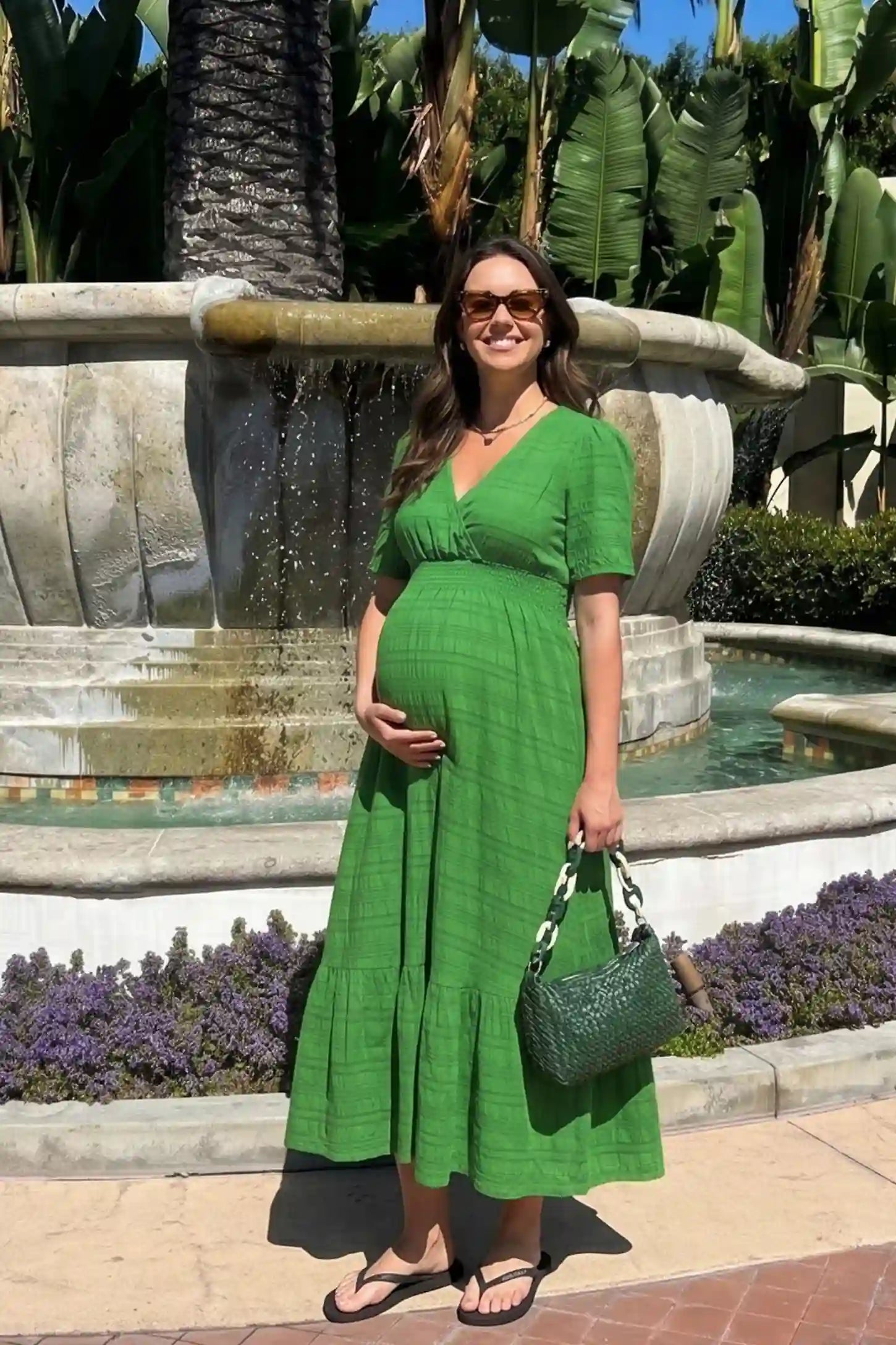 Textured Knit Butterfly Sleeve Maternity Midi Dress Textured Knit Butterfly Sleeve Midi Dress in Green featuring feminine short butterfly sleeves on a pregnant model, front view.