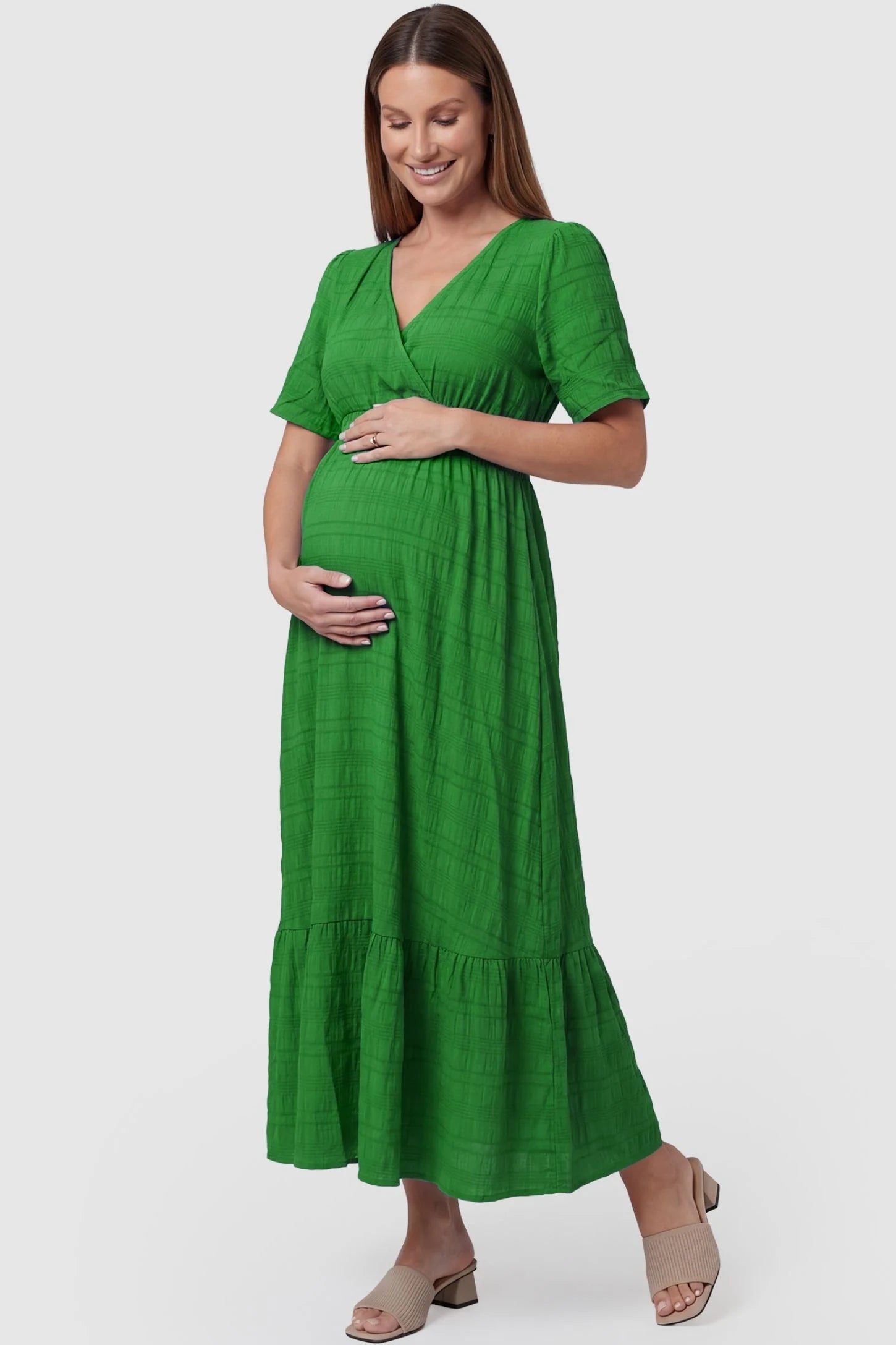 Textured Knit Butterfly Sleeve Maternity Midi Dress Textured Knit Butterfly Sleeve Midi Dress in Green featuring feminine short butterfly sleeves on a pregnant model, front view.