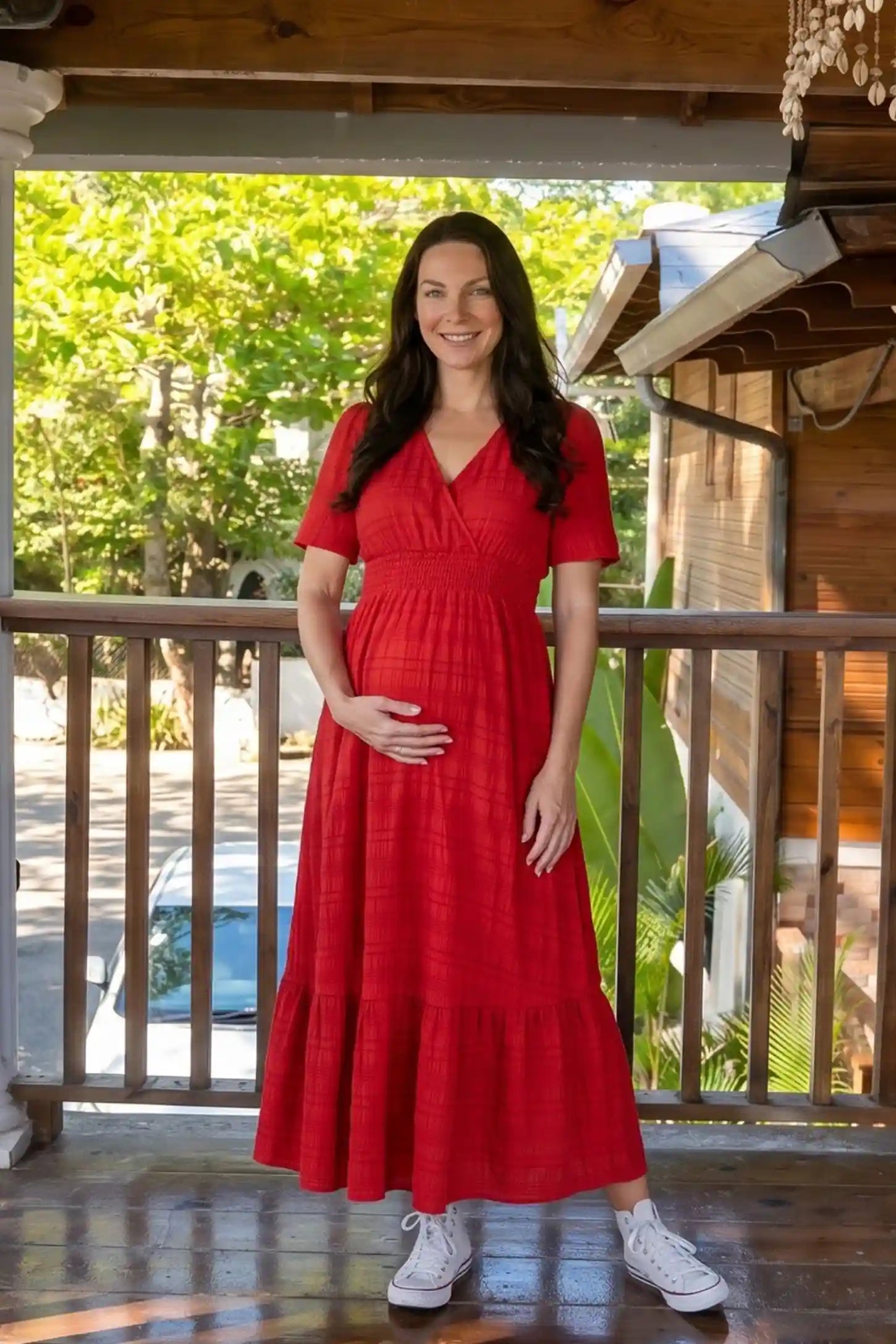 Textured Knit Butterfly Sleeve Maternity Midi Dress Textured Knit Butterfly Sleeve Midi Dress in Red featuring feminine short butterfly sleeves on a pregnant model, front view.