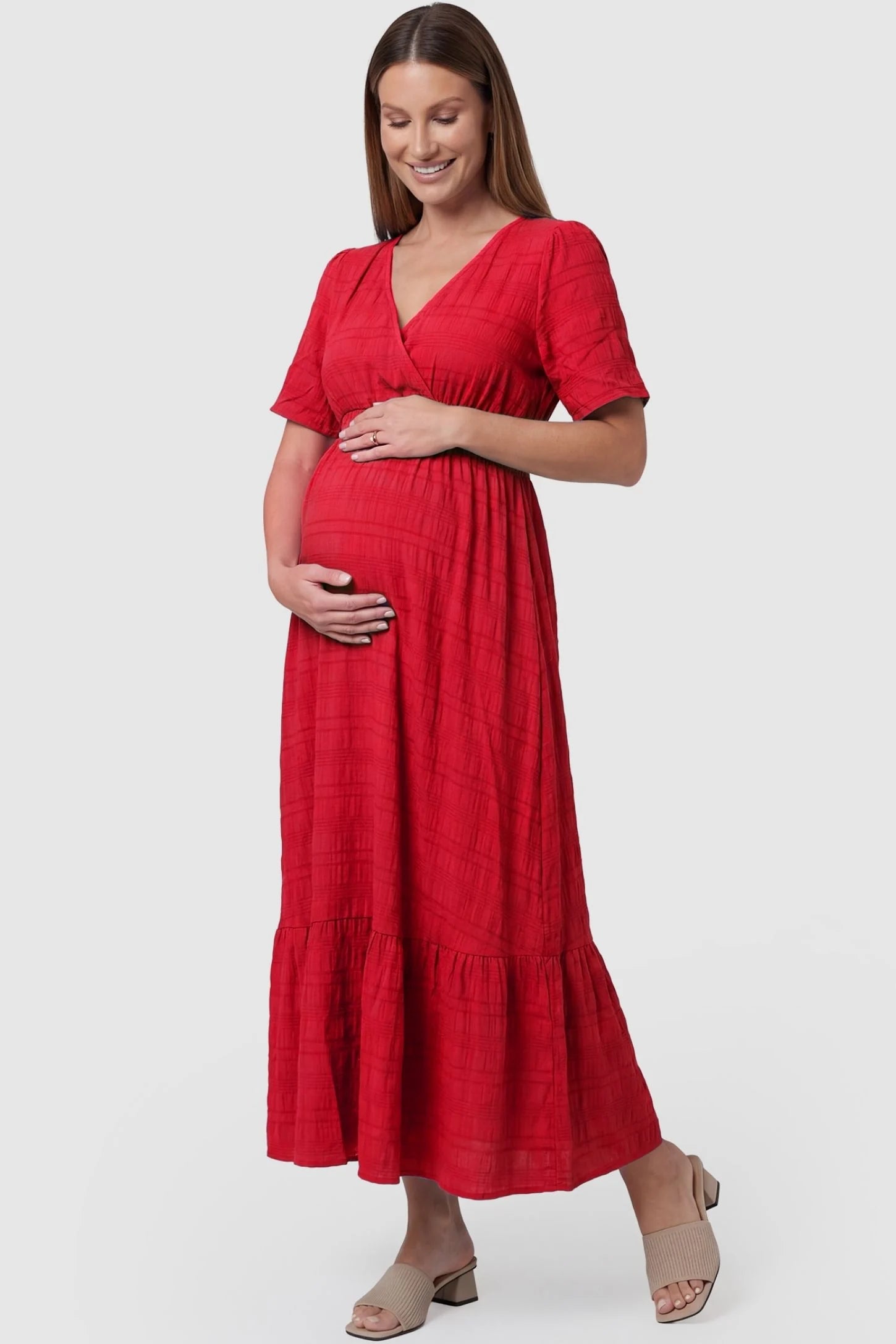 Textured Knit Butterfly Sleeve Maternity Midi Dress Textured Knit Butterfly Sleeve Midi Dress in Red featuring feminine short butterfly sleeves on a pregnant model, front view.