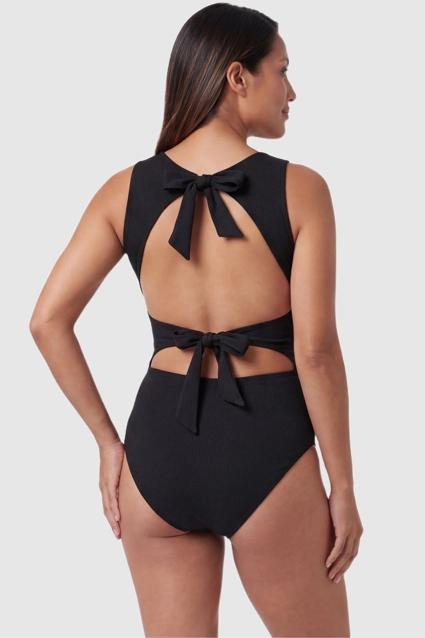 Ribbed Tie-Back Maternity Monokini Tie-Back High-Neck Maternity Monokini in Black with adjustable tie-back detail on a pregnant model, back view.