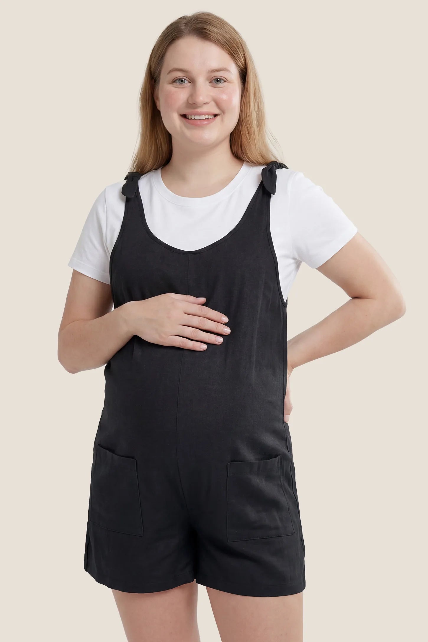 Tie-Strap Sleeveless Pocketed Maternity Romper Front view of the black Tie-Strap Sleeveless Pocketed Maternity Romper with pockets and a comfortable maternity fit.