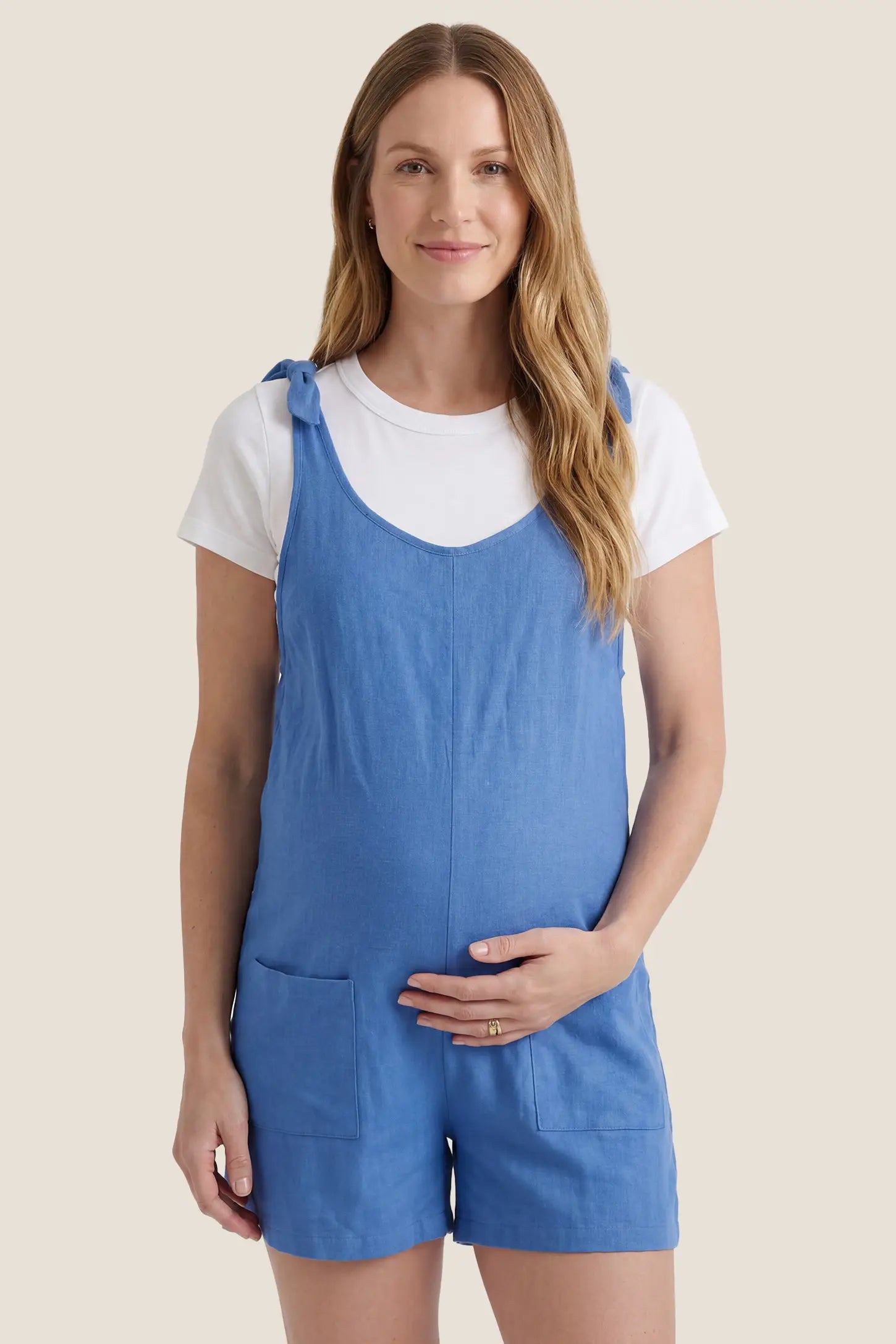 Tie-Strap Sleeveless Pocketed Maternity Romper Front view of the blue Tie-Strap Sleeveless Pocketed Maternity Romper with pockets and a comfortable maternity fit.