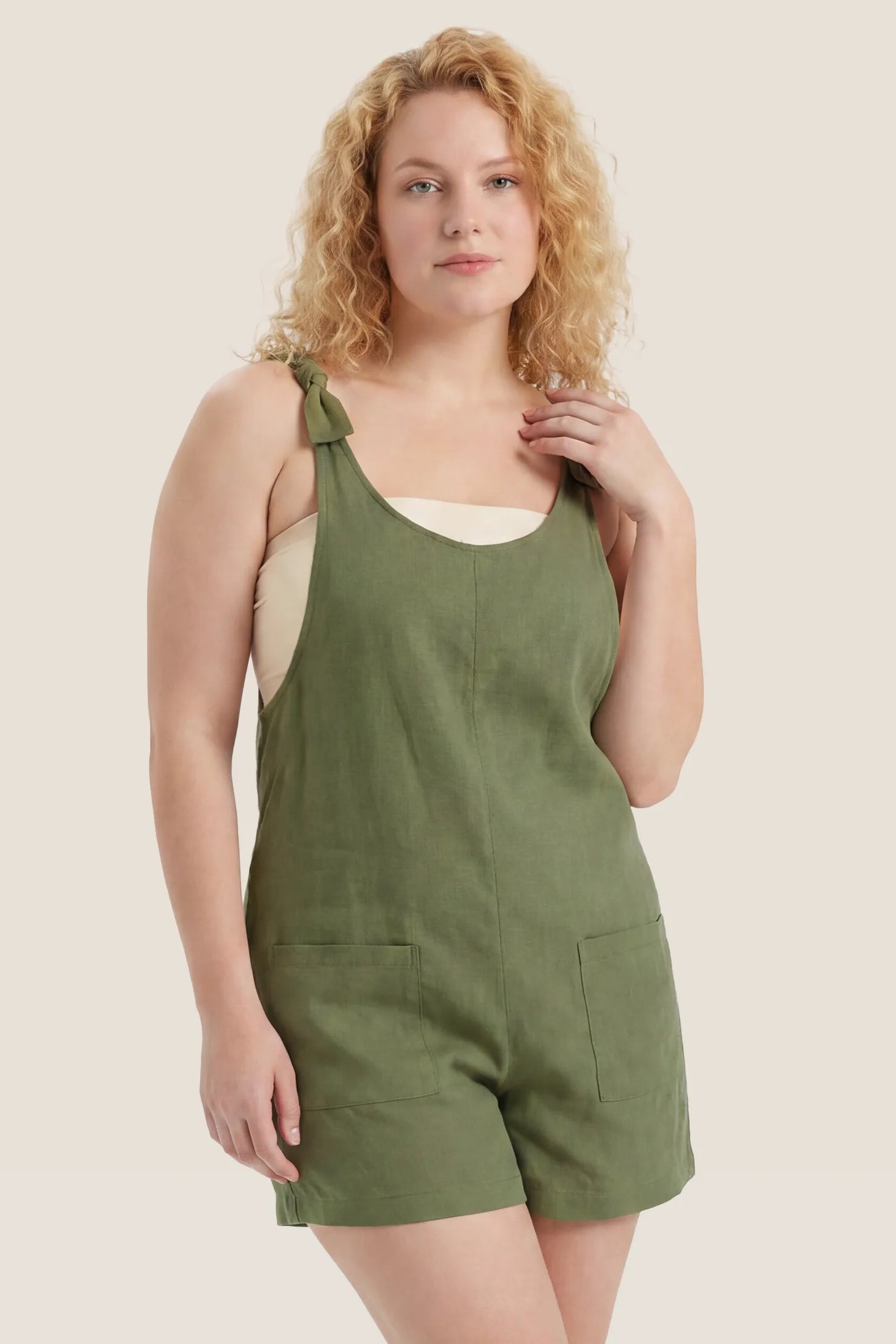 Tie-Strap Sleeveless Pocketed Maternity Romper Front view of the green Tie-Strap Sleeveless Pocketed Maternity Romper with a sleeveless design and roomy fit.
