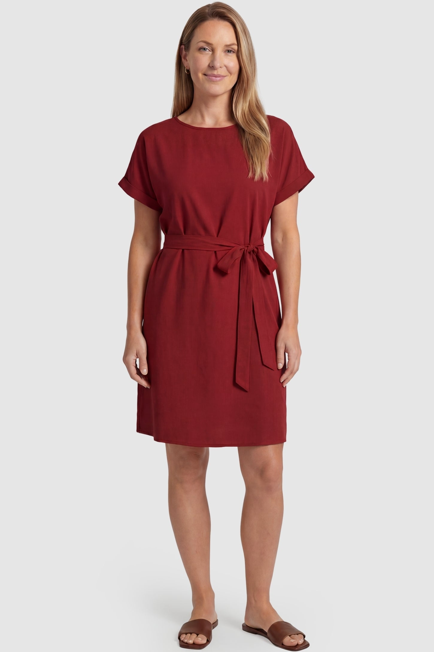 Lightweight Short Sleeve Tie Waist Flowy Maternity Mini Dress Lightweight Short Sleeve Tie Waist Flowy Maternity Mini Dress in Rust featuring a relaxed empire waist tie on a non-pregnant model, postpartum view.